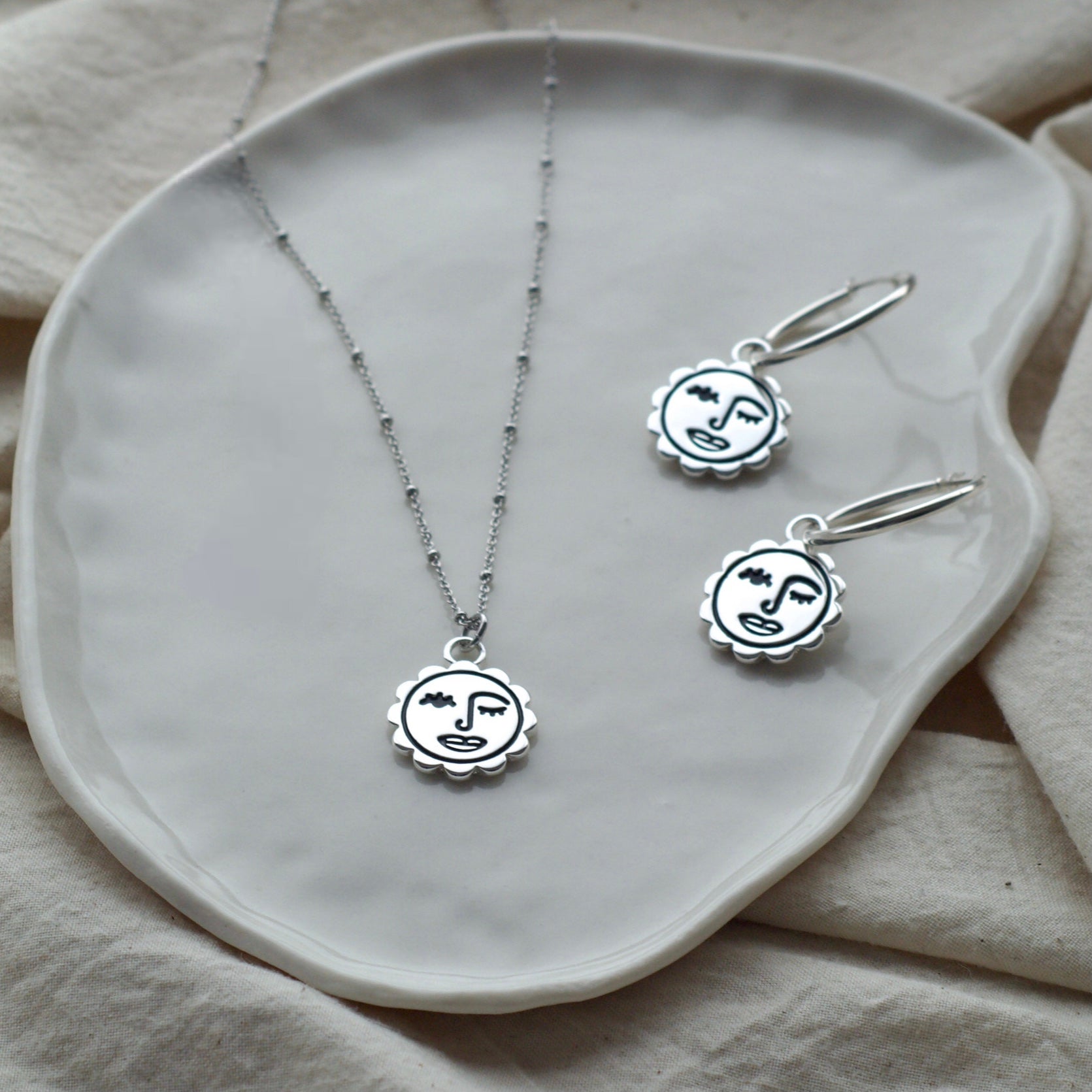 Winking sun face necklace
