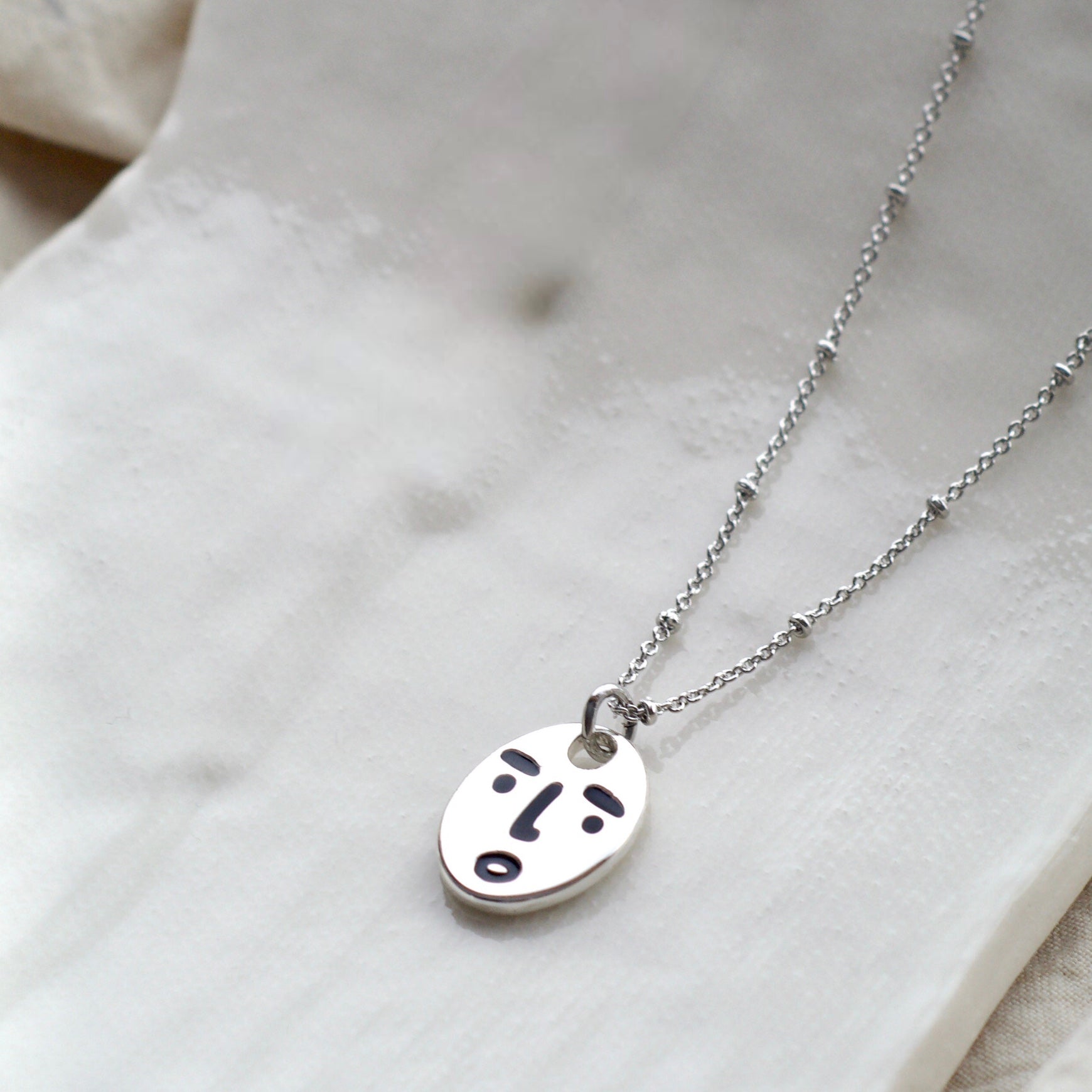 Clueless face necklace