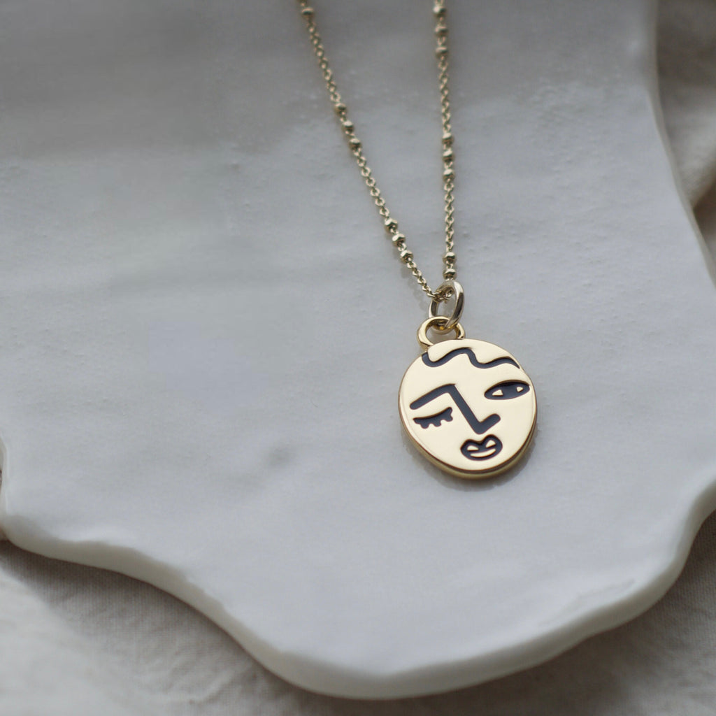 Winking lady face necklace