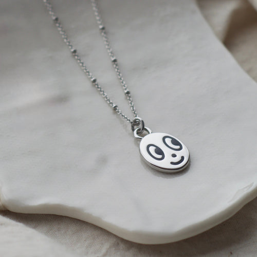 Big eyed smiley face necklace