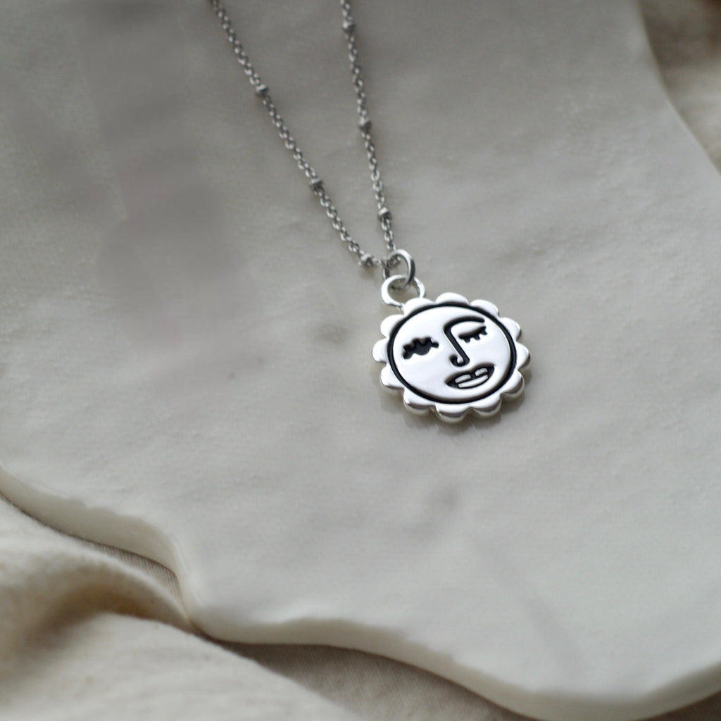 Winking sun face necklace