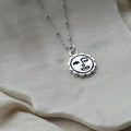 Winking sun face necklace