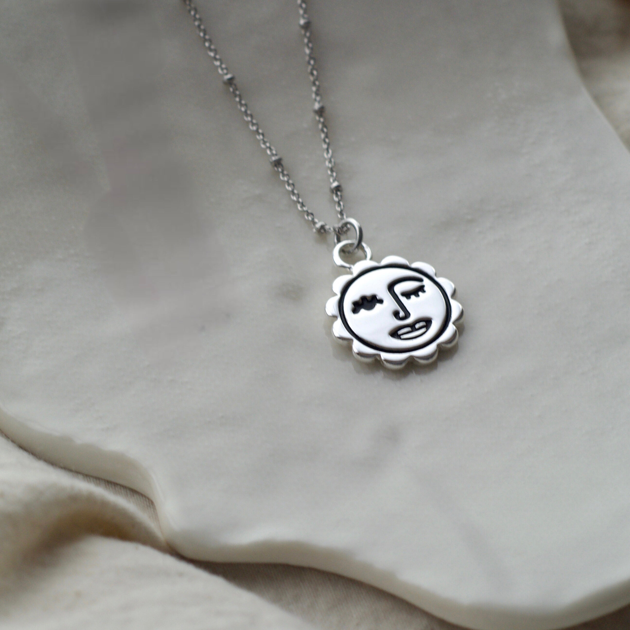 Winking sun face necklace