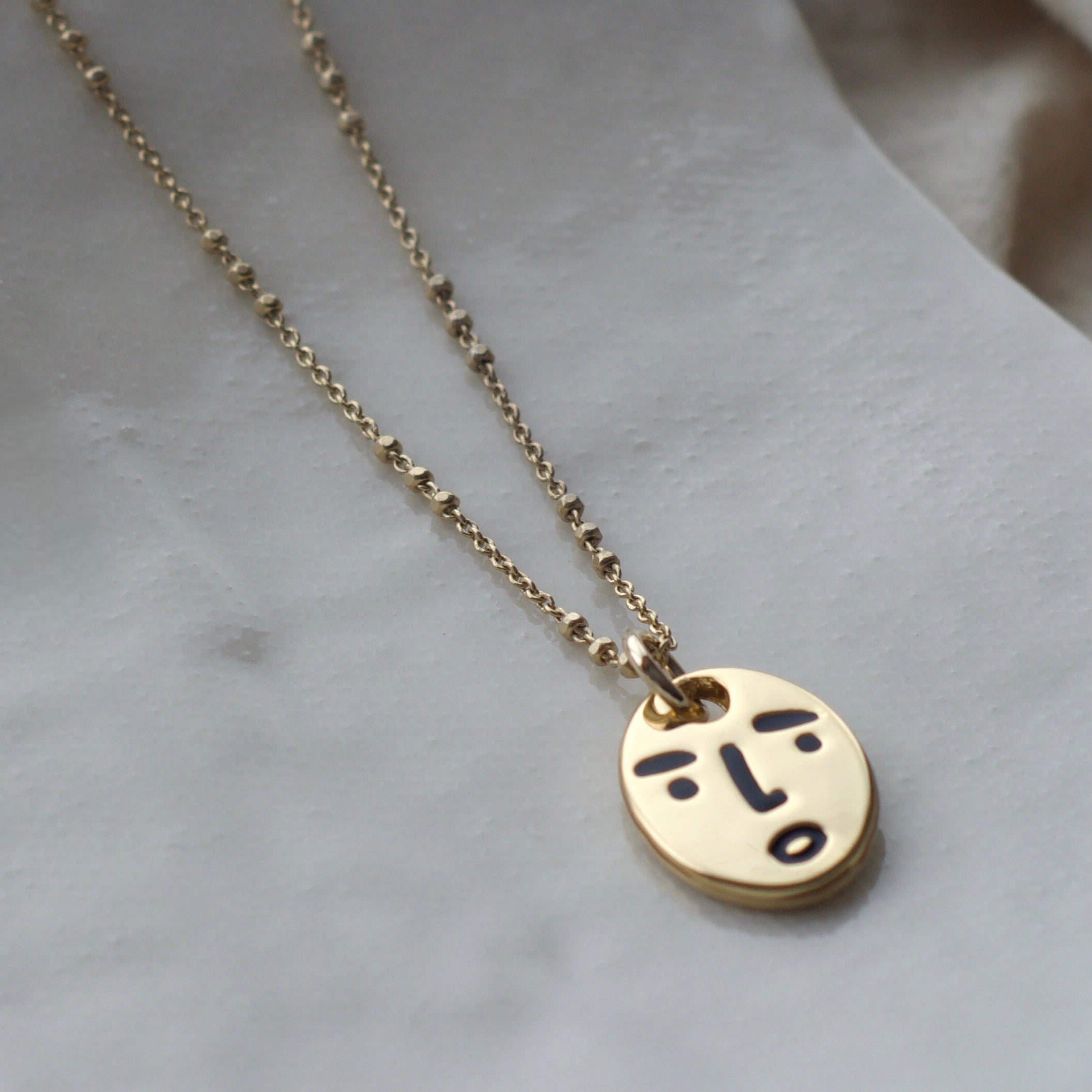 Clueless face necklace