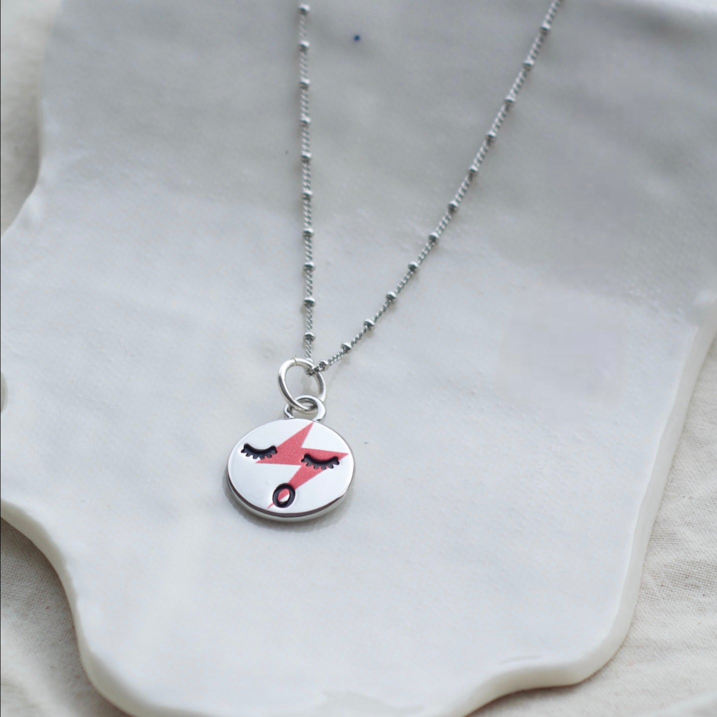 Red lightening face necklace