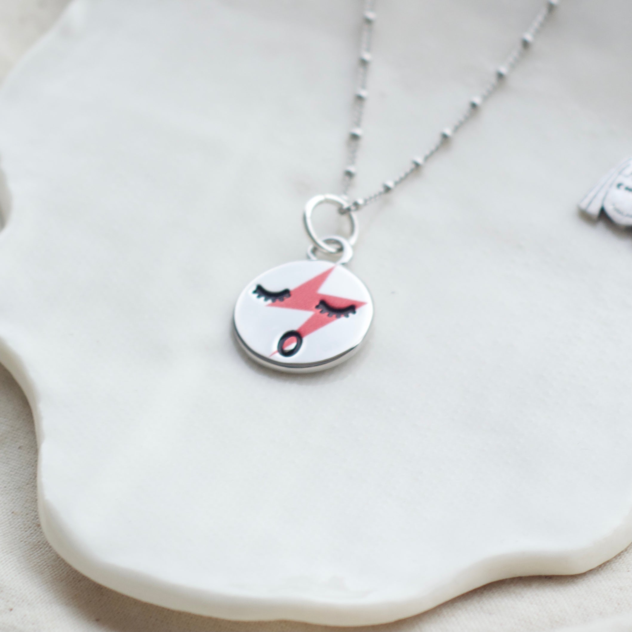 Red lightening face necklace