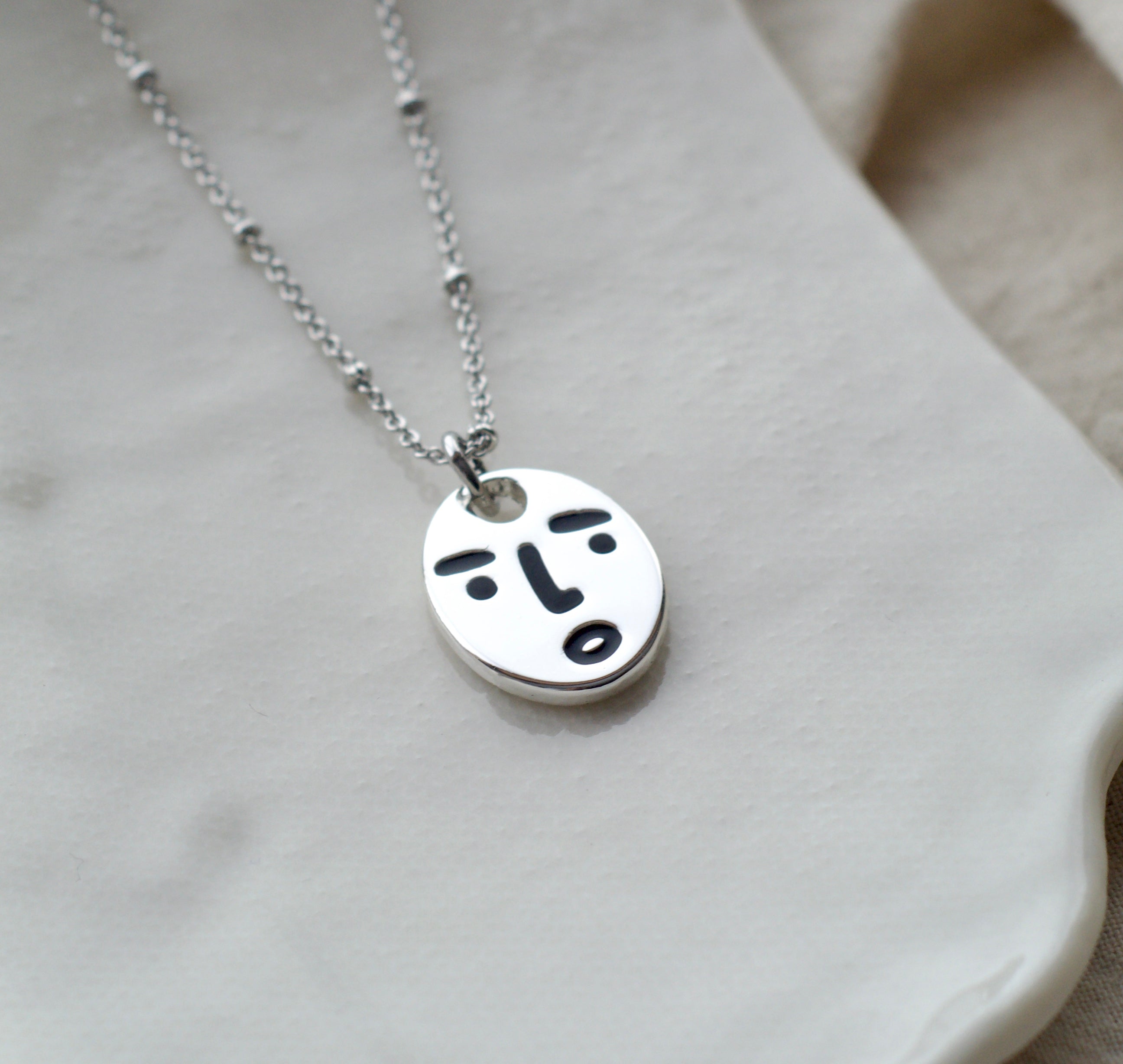 Clueless face necklace