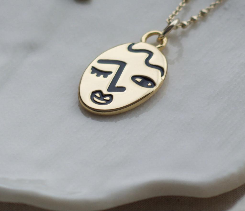 Winking lady face necklace