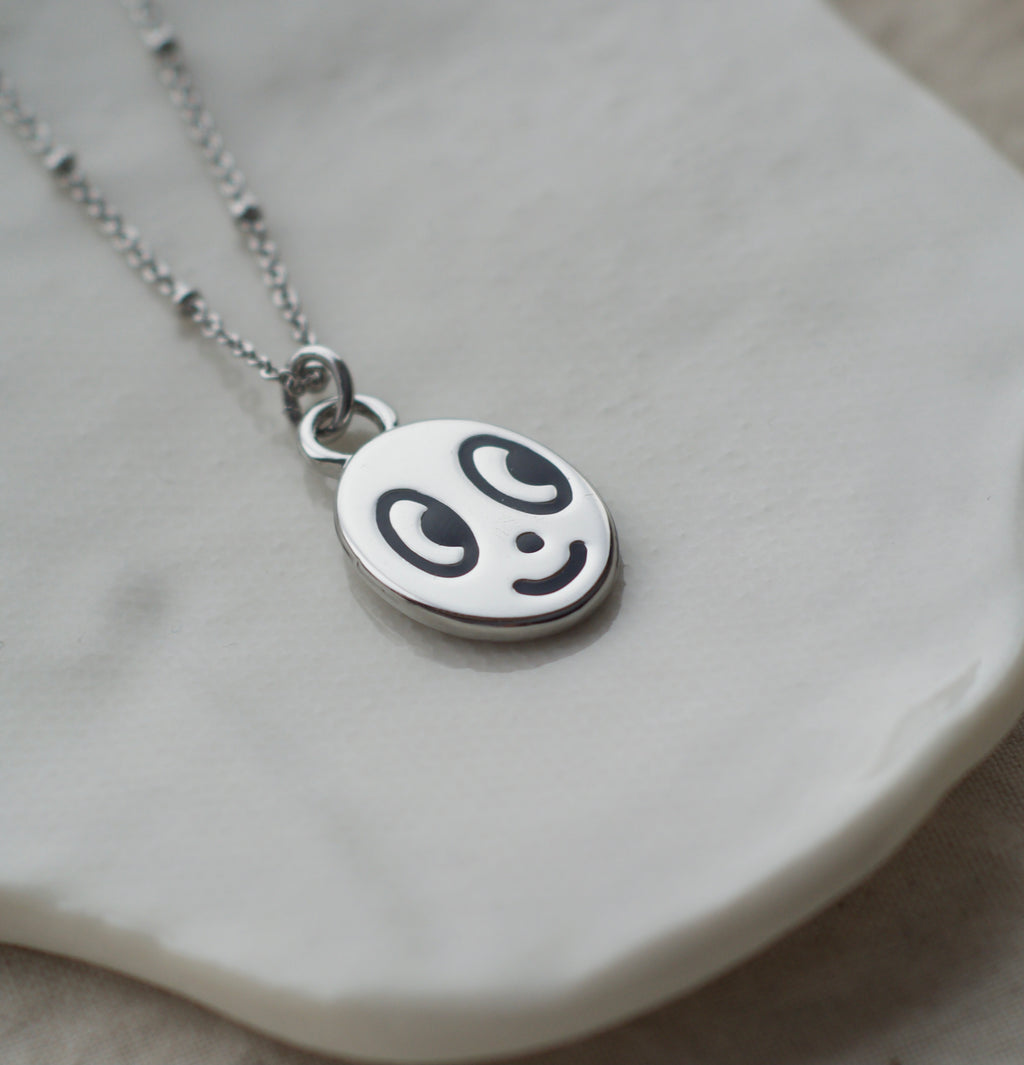 Big eyed smiley face necklace