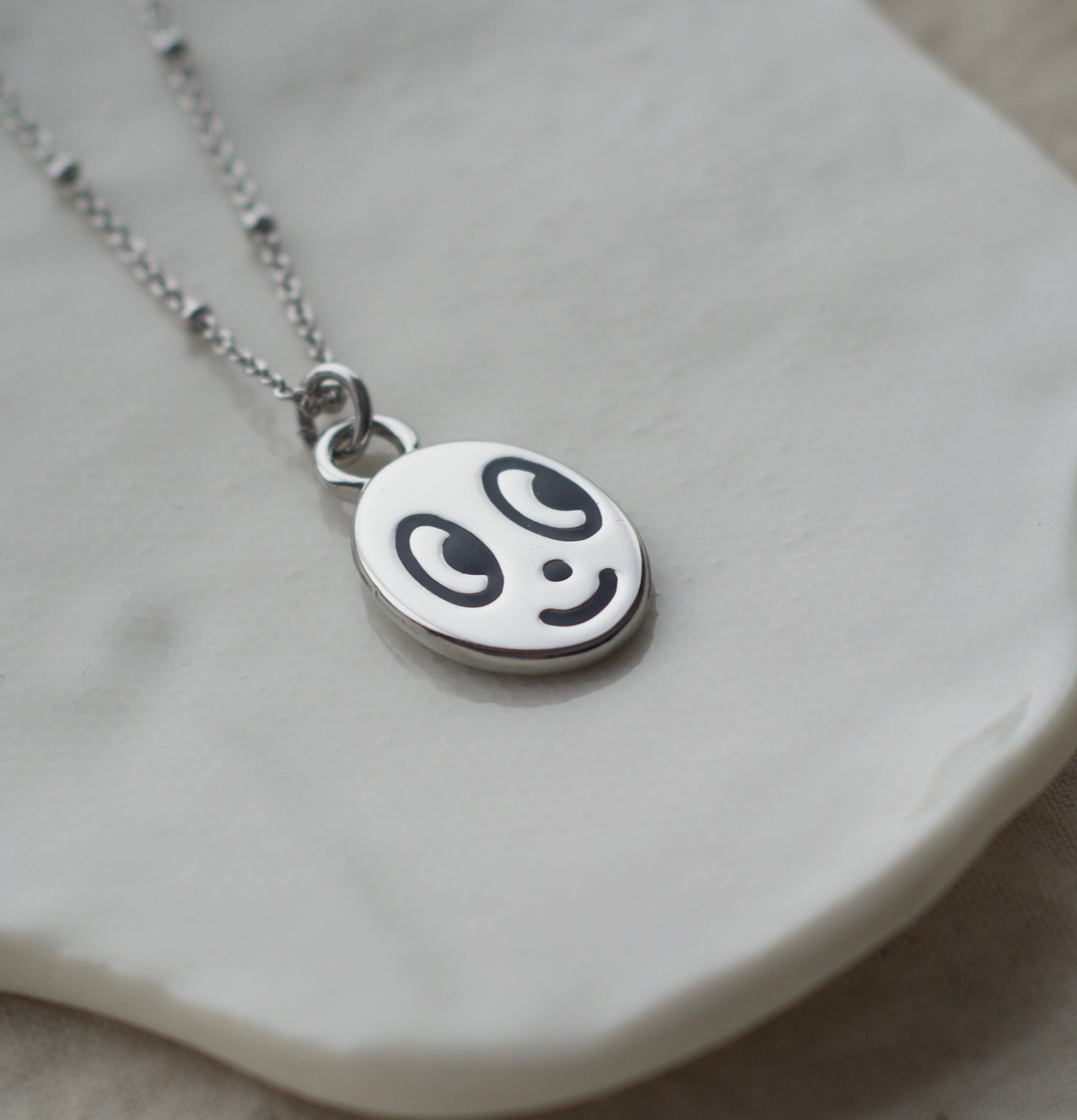 Big eyed smiley face necklace