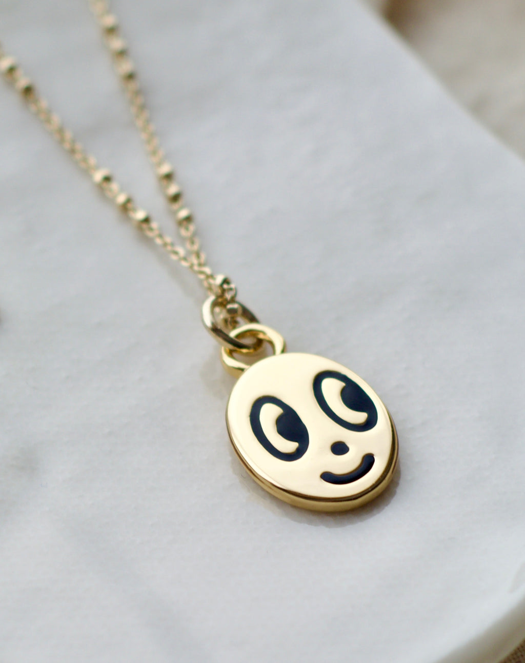 Big eyed smiley face necklace
