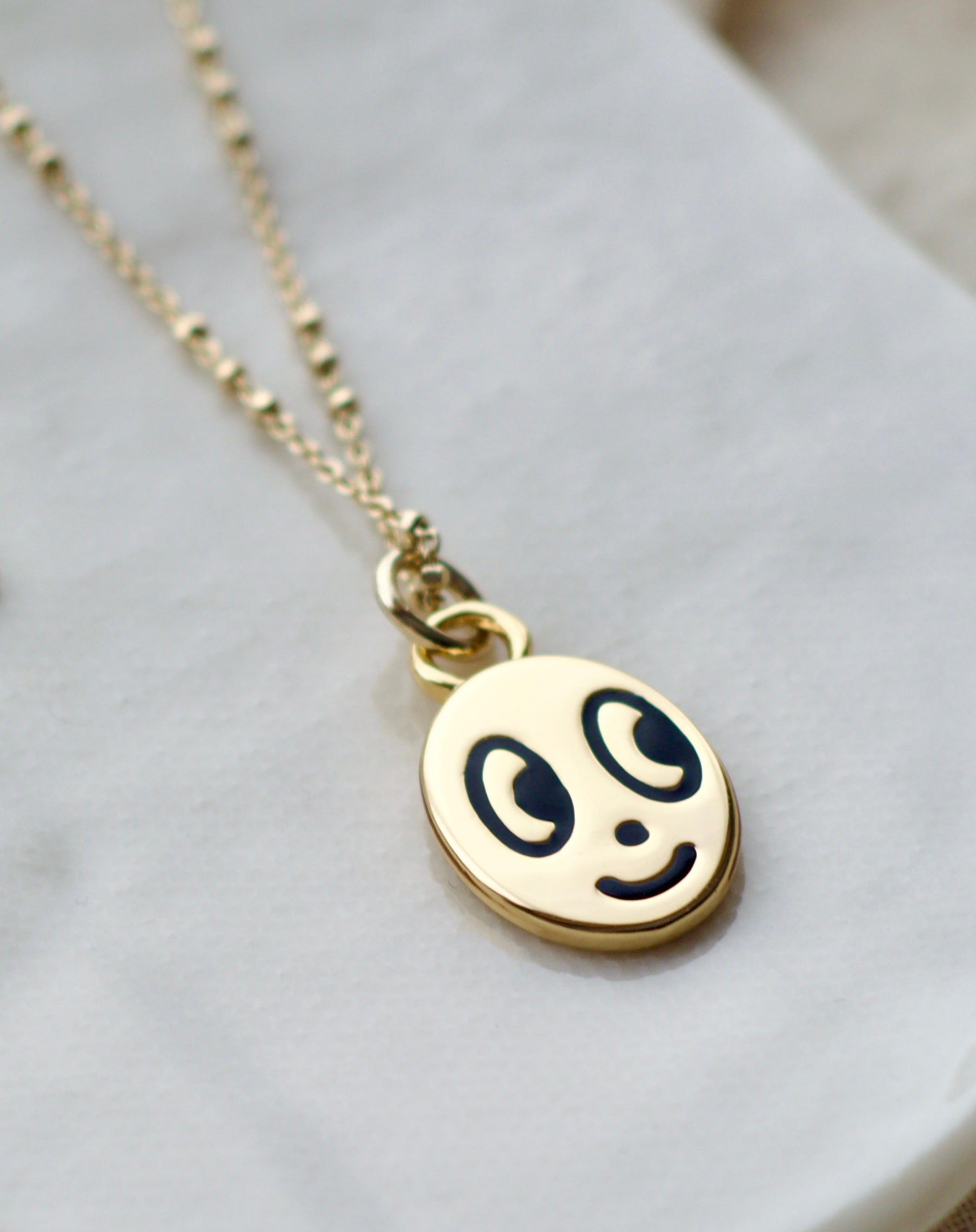 Big eyed smiley face necklace