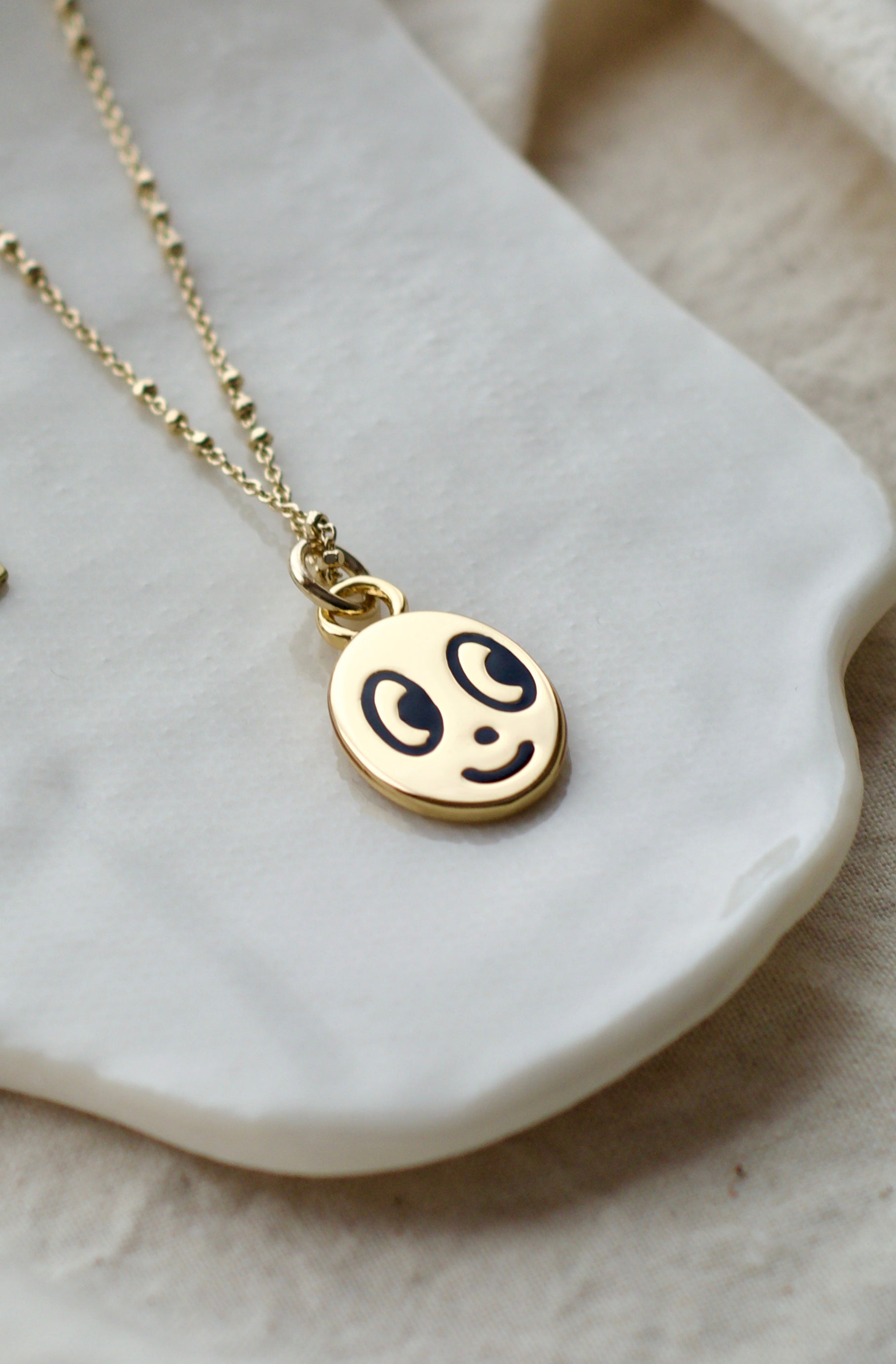 Big eyed smiley face necklace