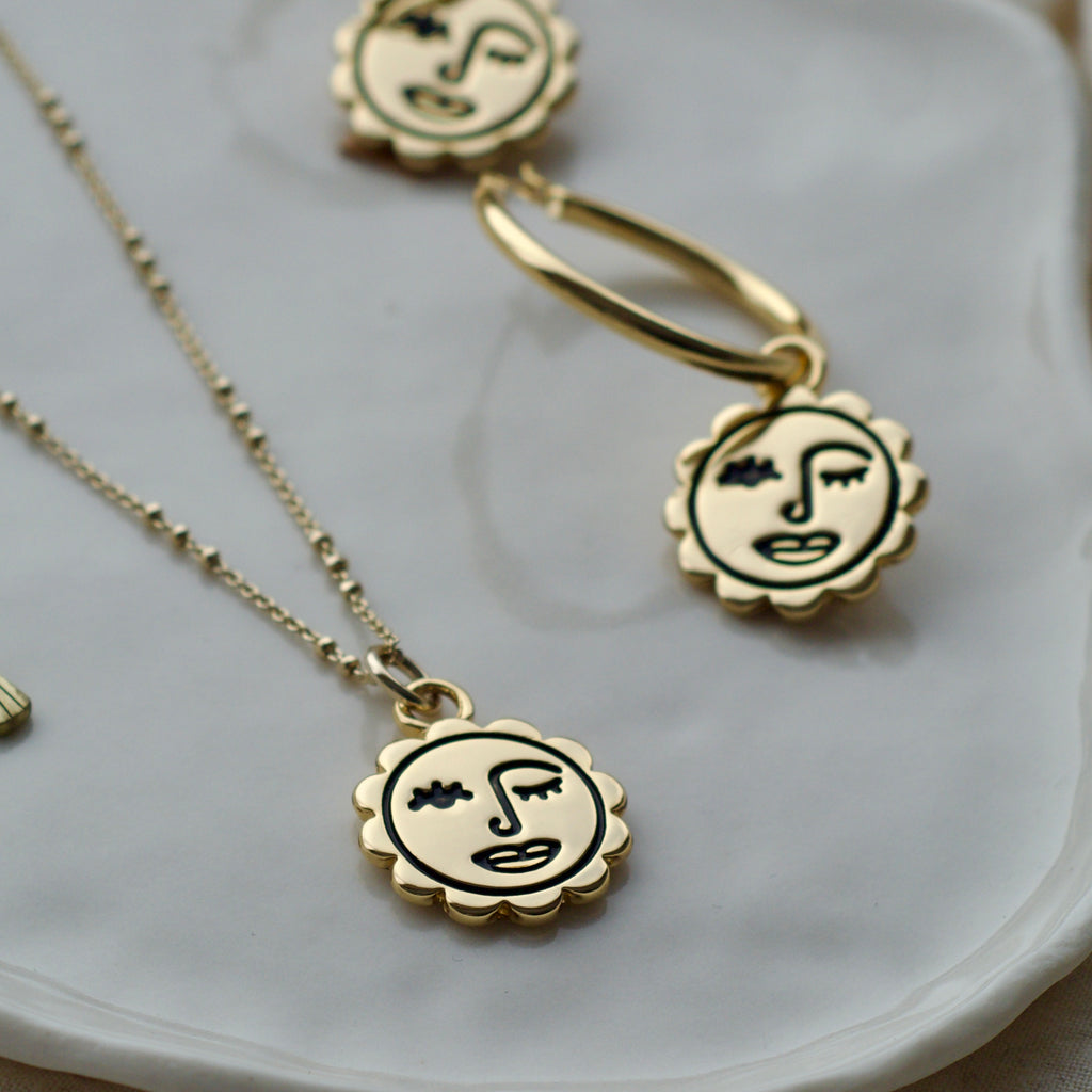 Winking sun face necklace