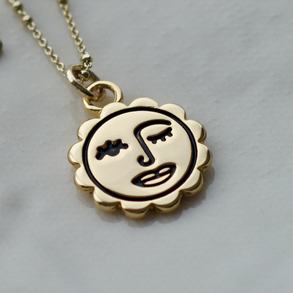 Winking sun face necklace