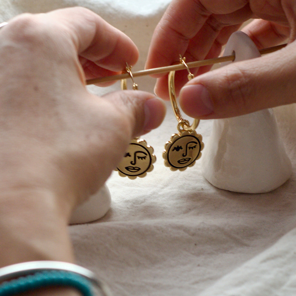Winking sun face hoop earrings