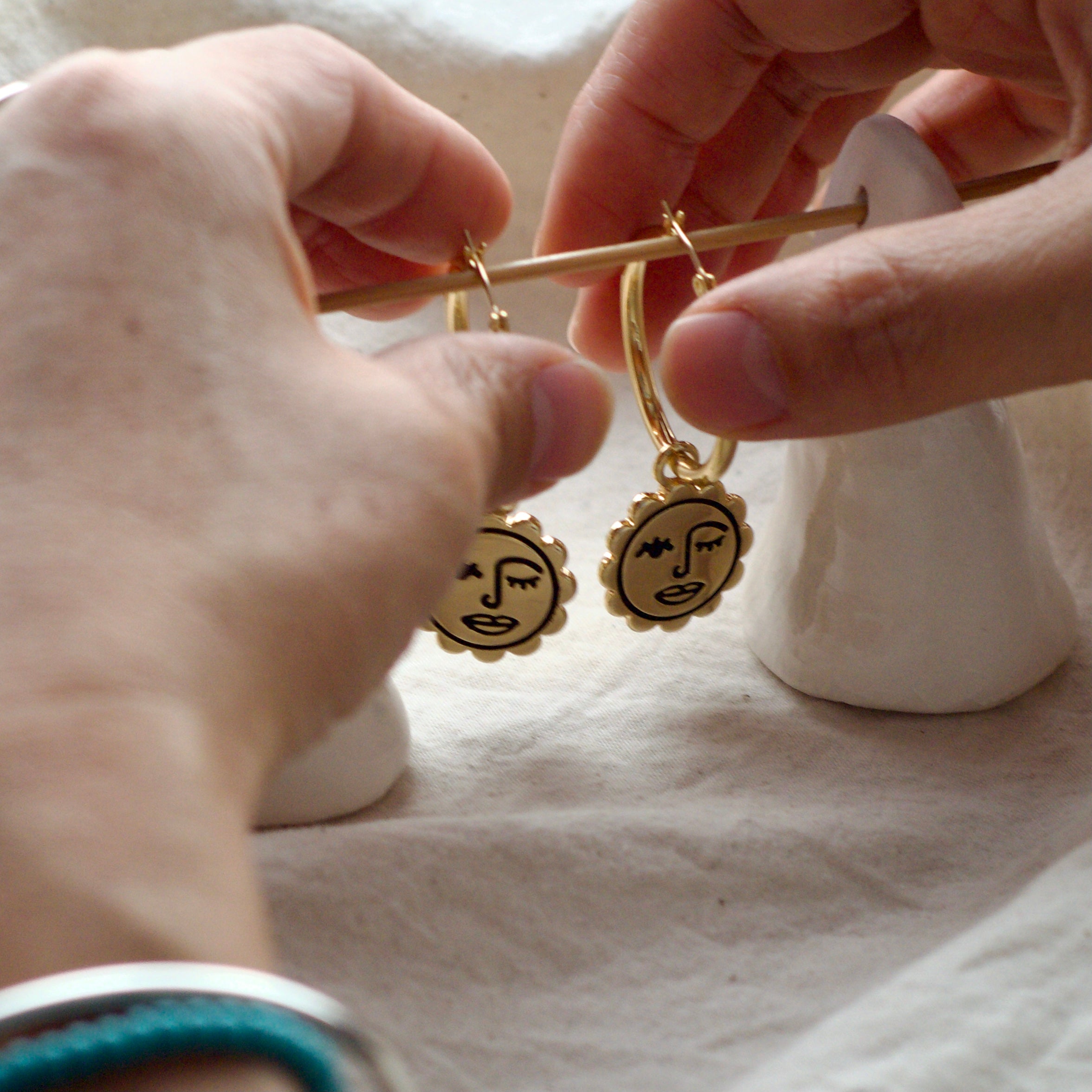 Winking sun face hoop earrings