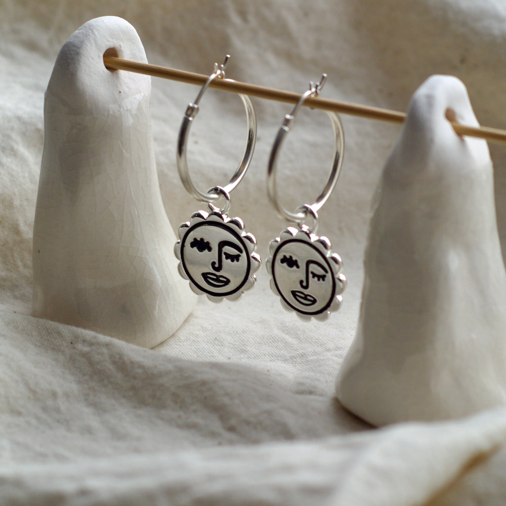 Winking sun face hoop earrings