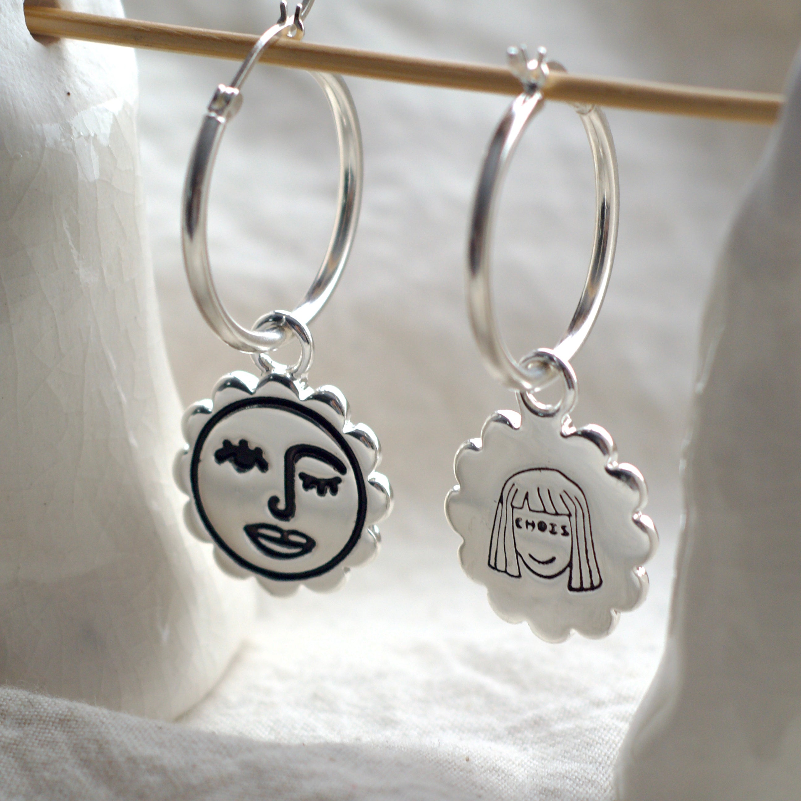 Winking sun face hoop earrings