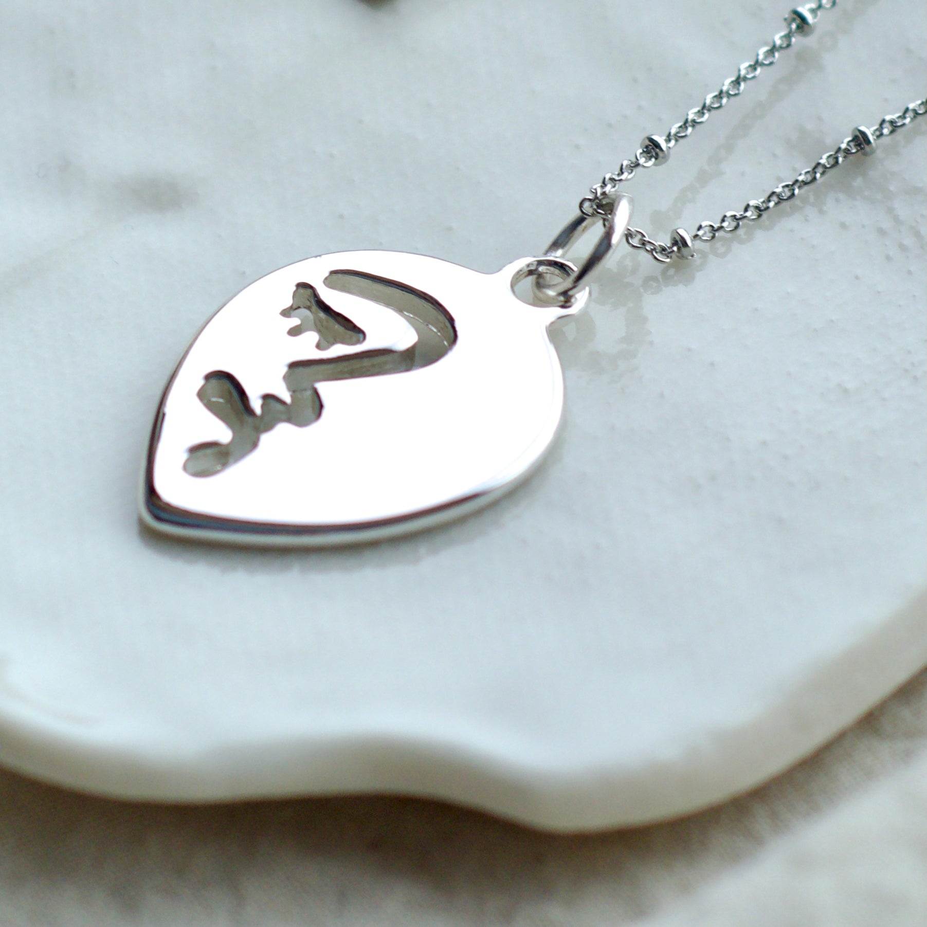 Half abstract face necklace