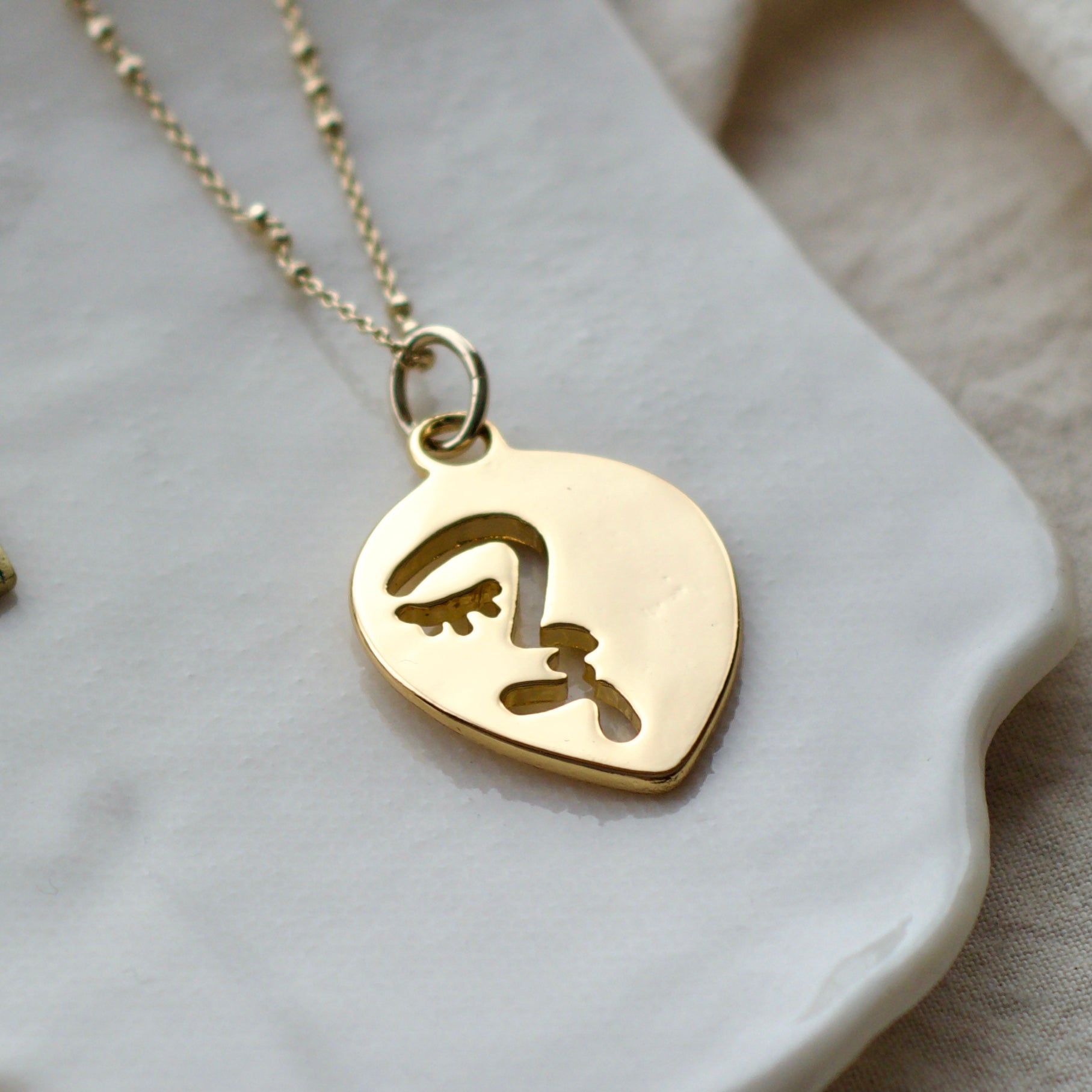 Half abstract face necklace