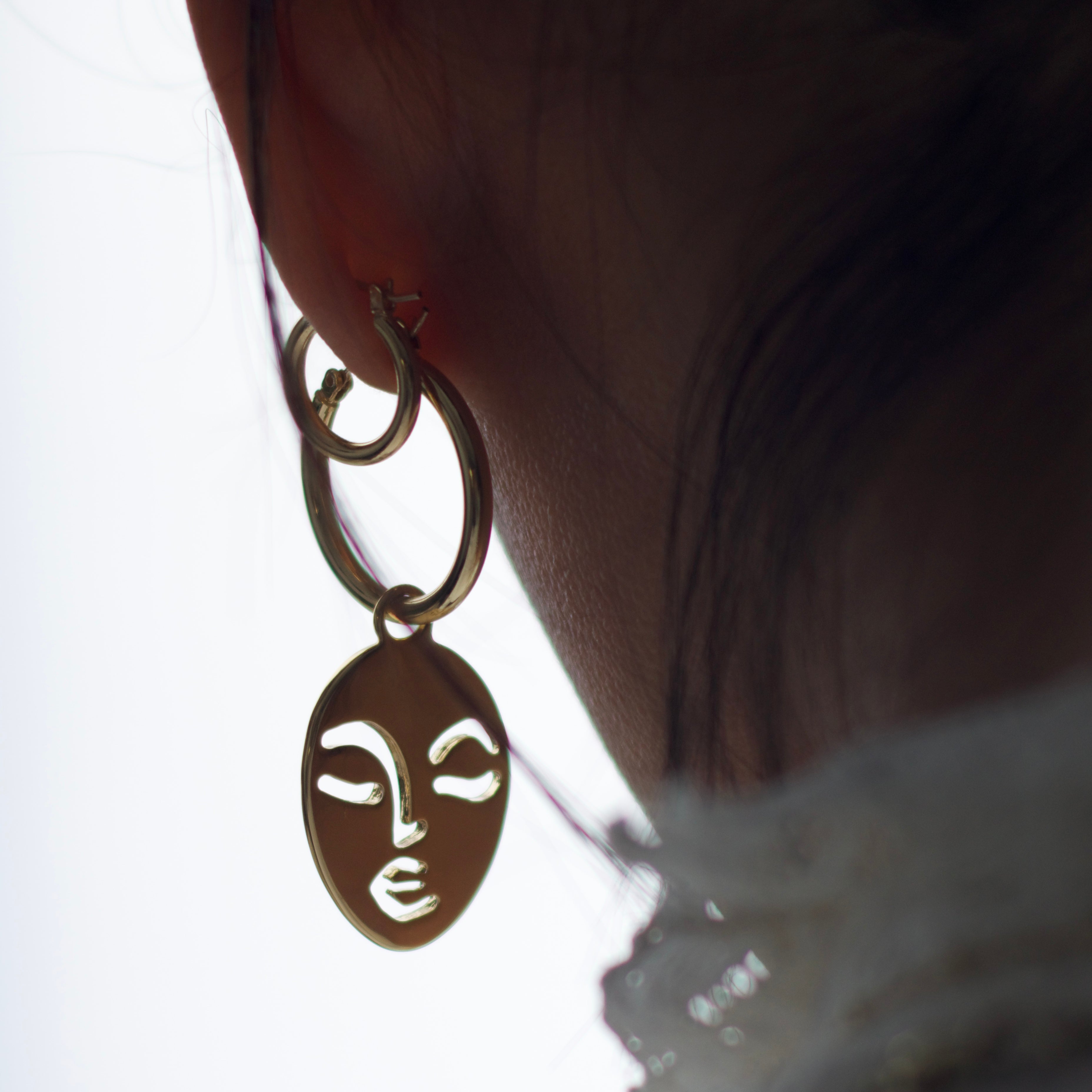 Calm and Sallow face hoop earrings