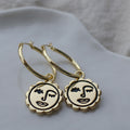 Winking sun face hoop earrings