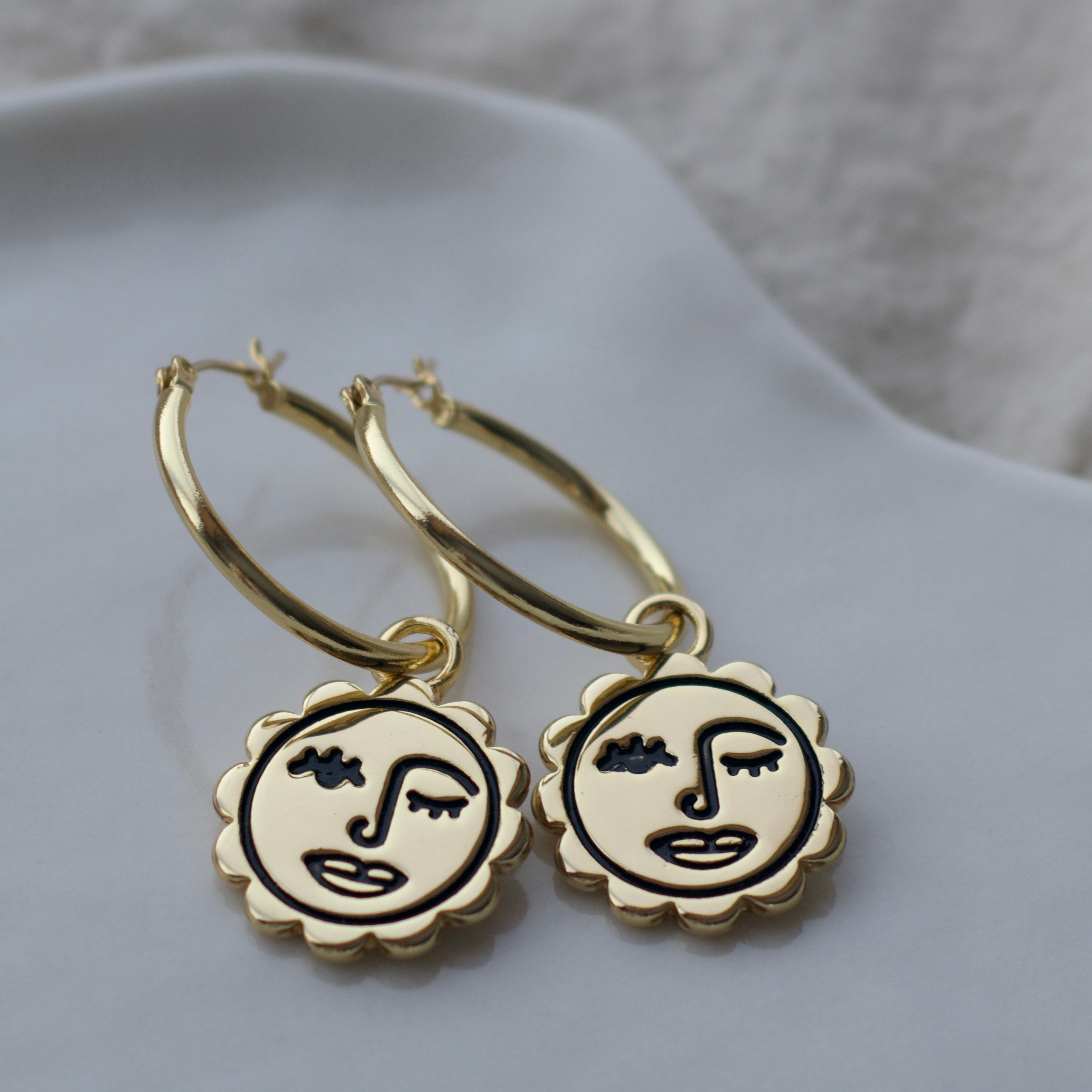 Winking sun face hoop earrings