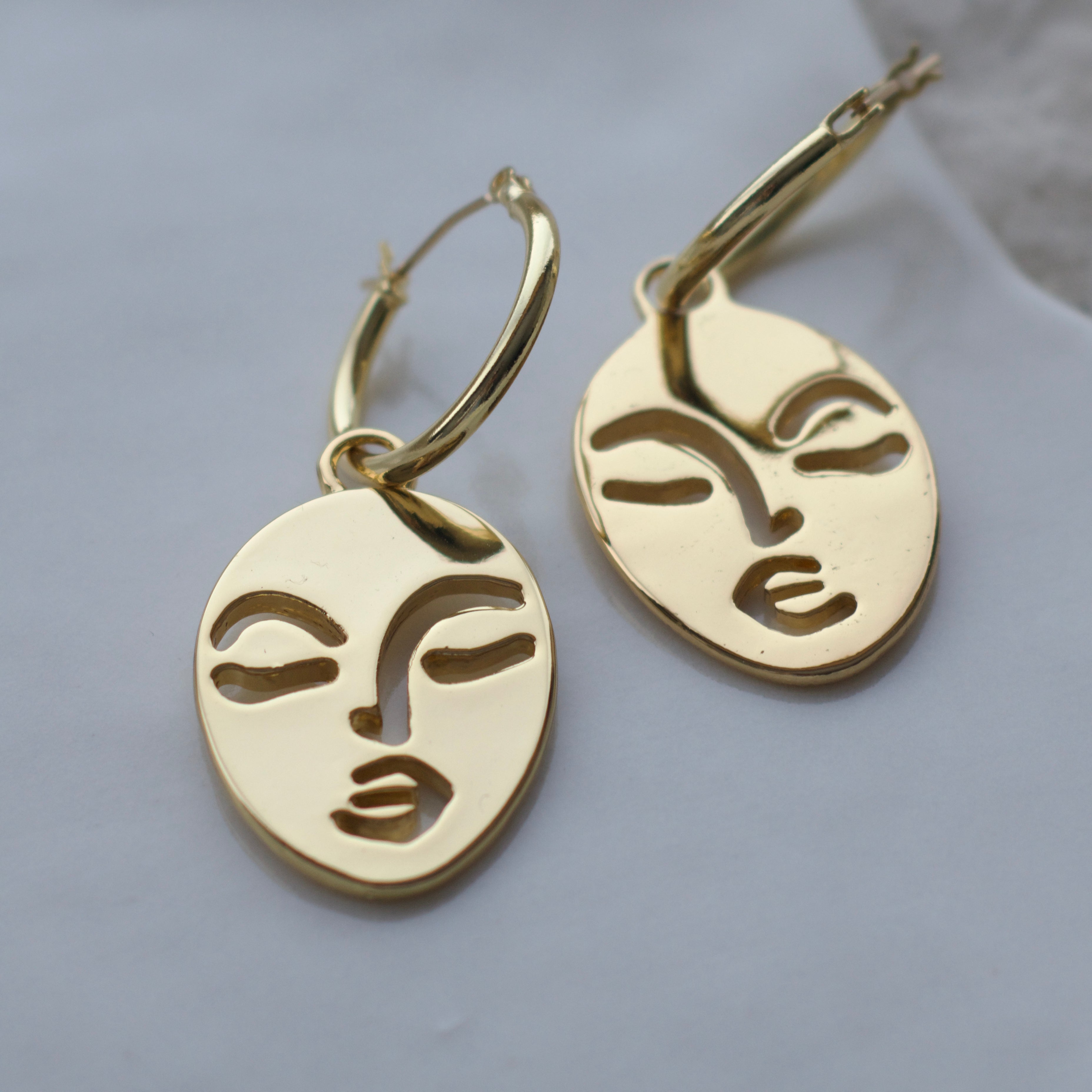 Calm and Sallow face hoop earrings