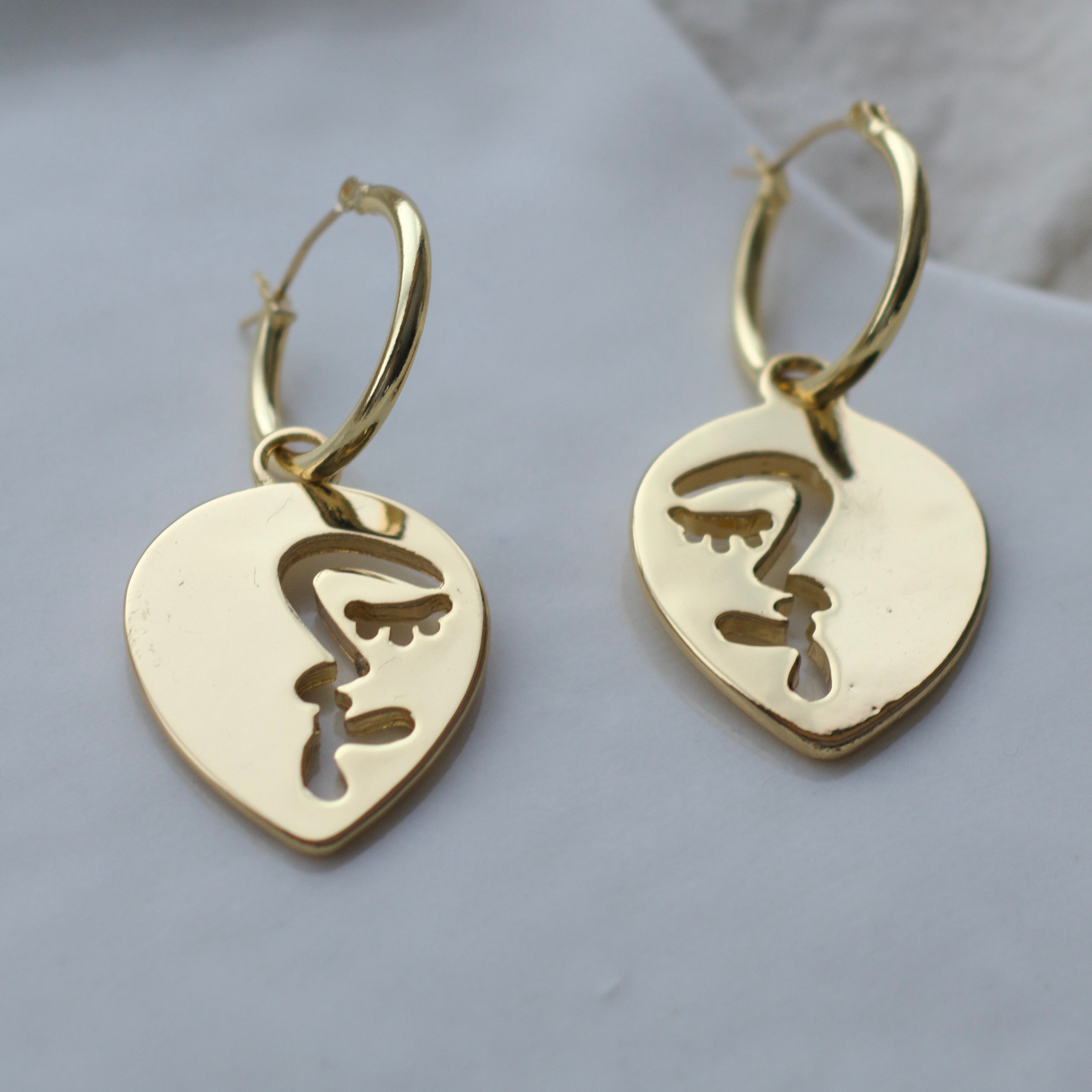 Half abstract face hoop earrings