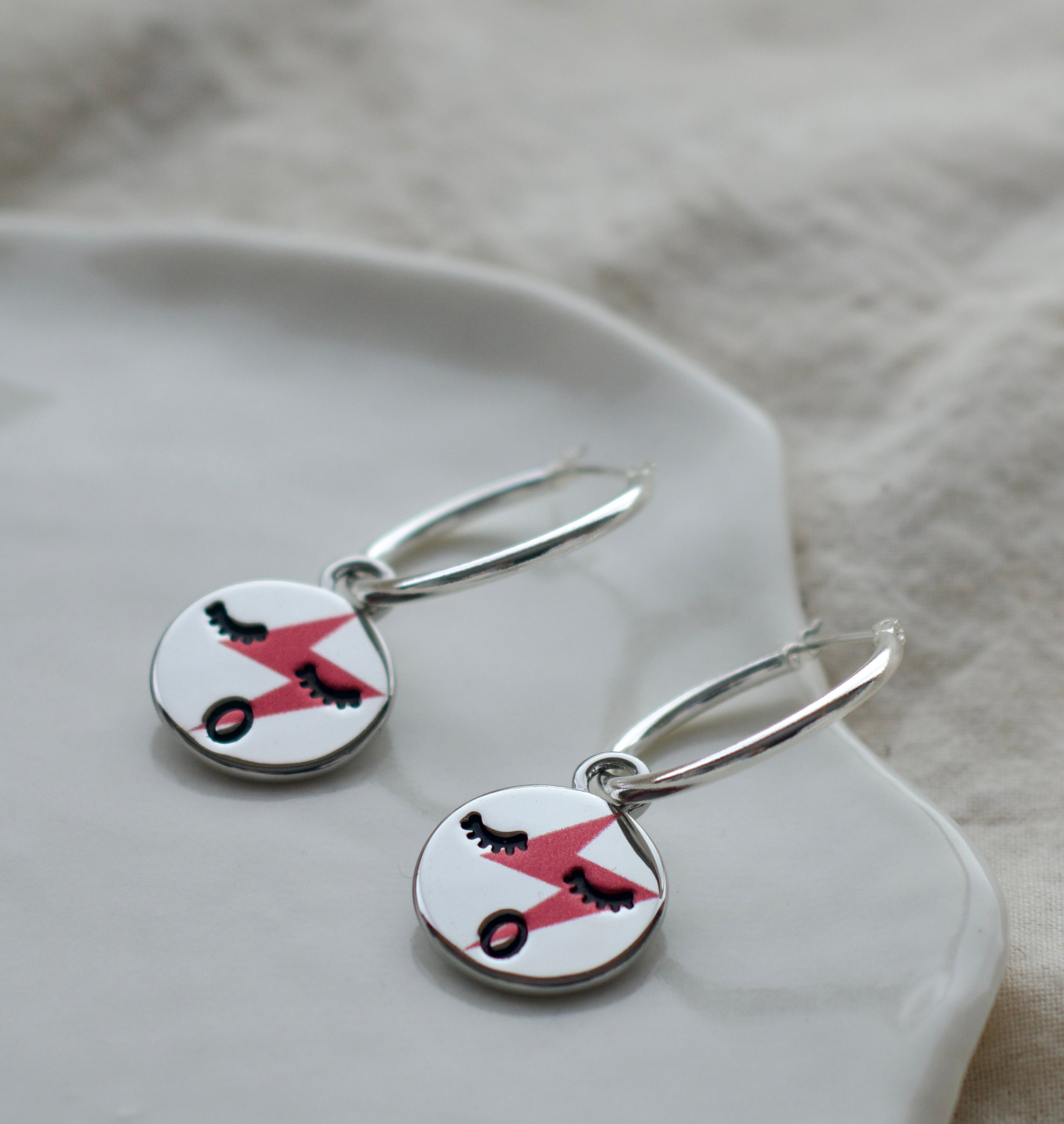 Red lightening face hoop earrings