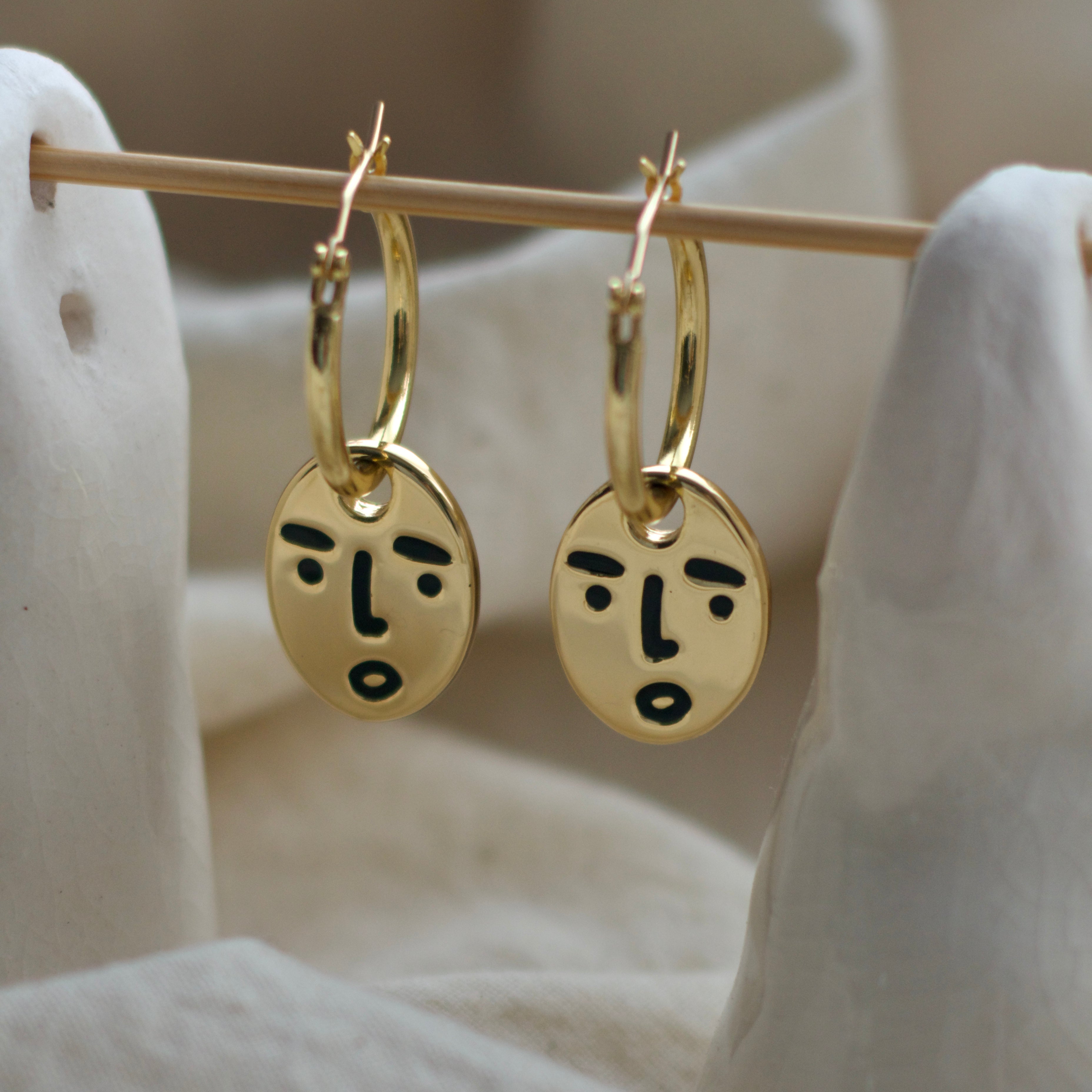 Clueless face hoop earrings