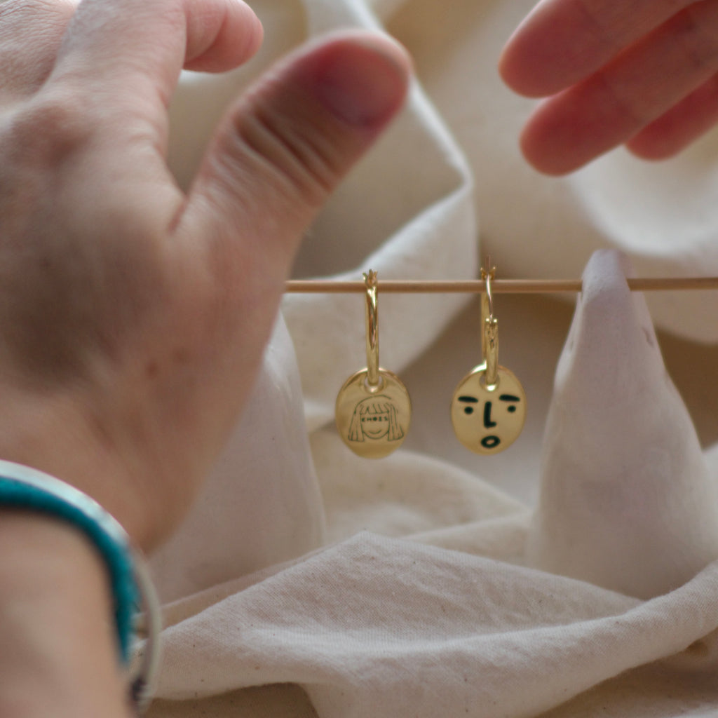 Clueless face hoop earrings