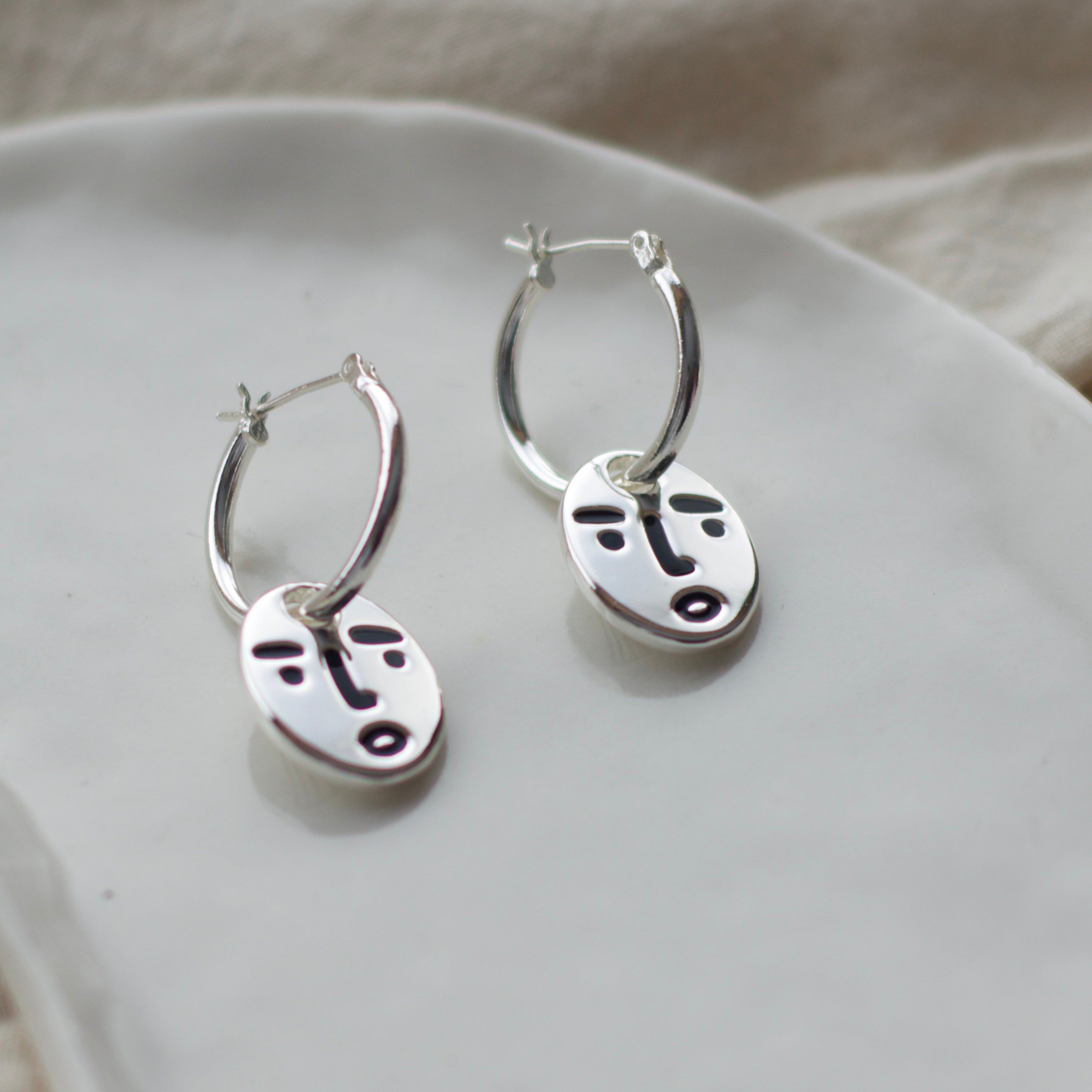 Clueless face hoop earrings