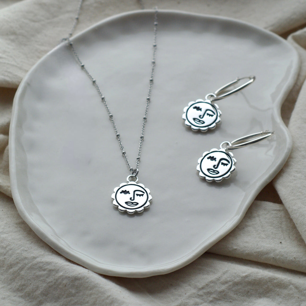Winking sun face hoop earrings