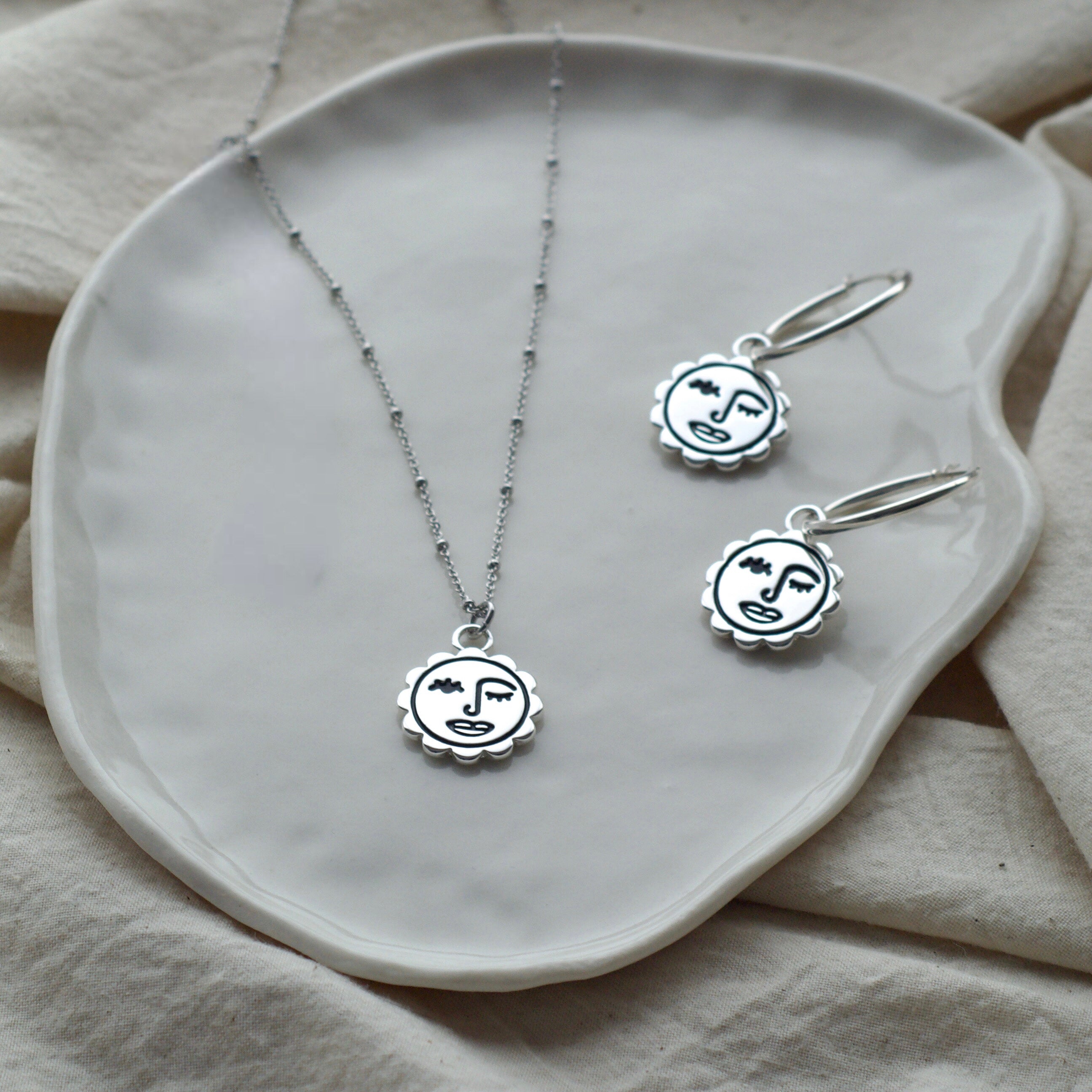 Winking sun face hoop earrings