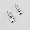 Clueless face hoop earrings