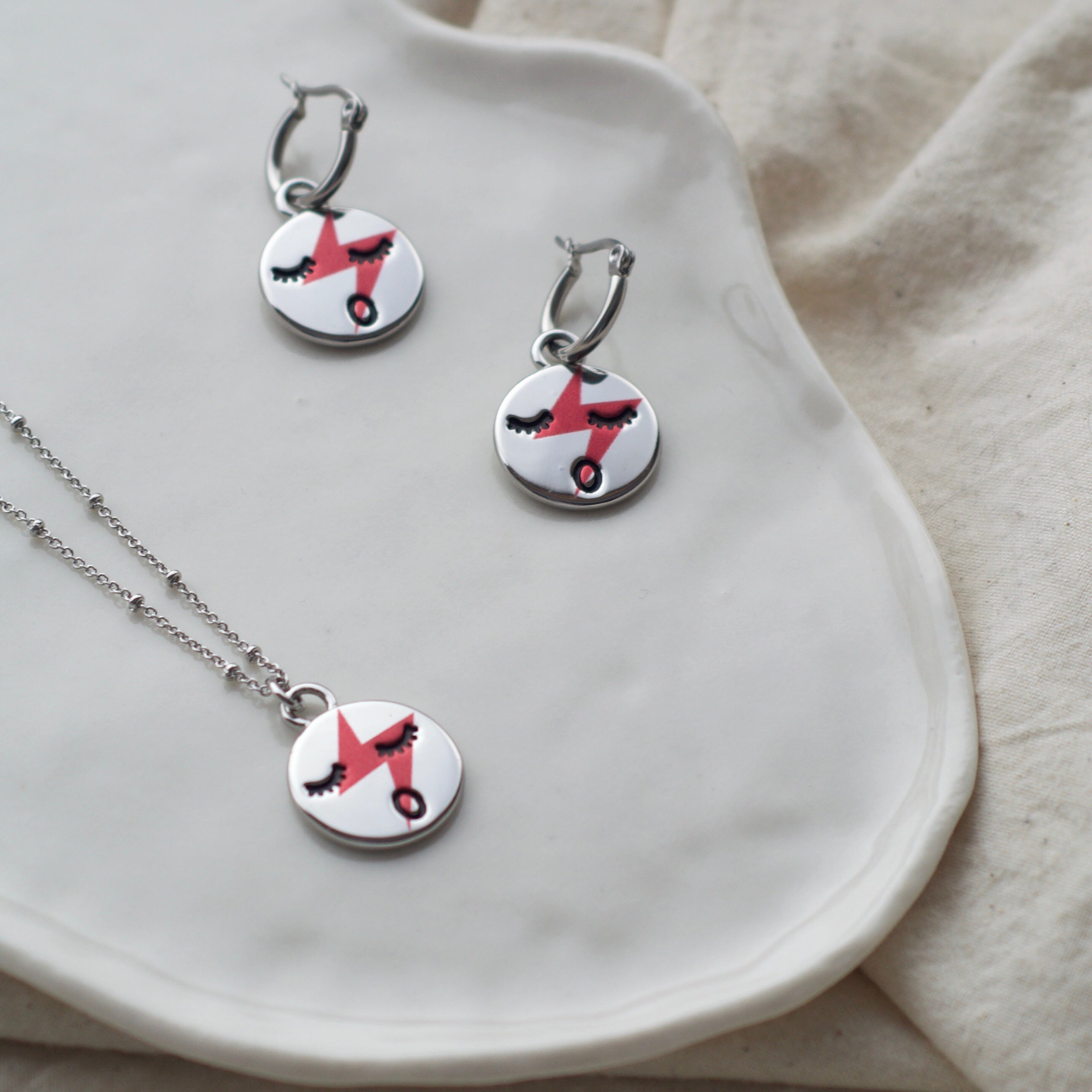 Red lightening face hoop earrings