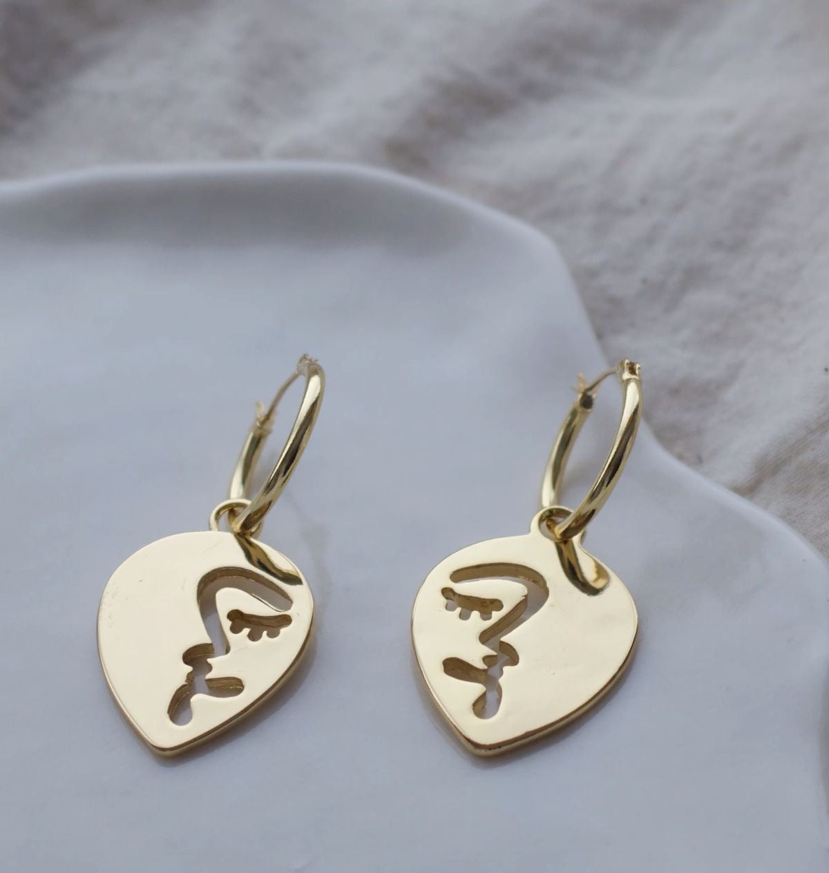 Half abstract face hoop earrings