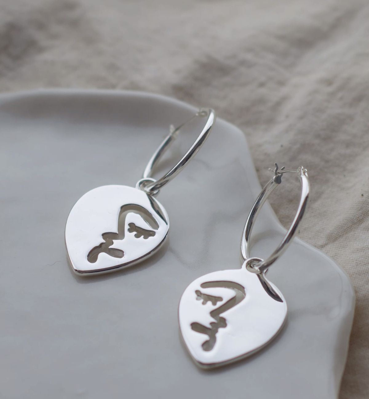 Half abstract face hoop earrings
