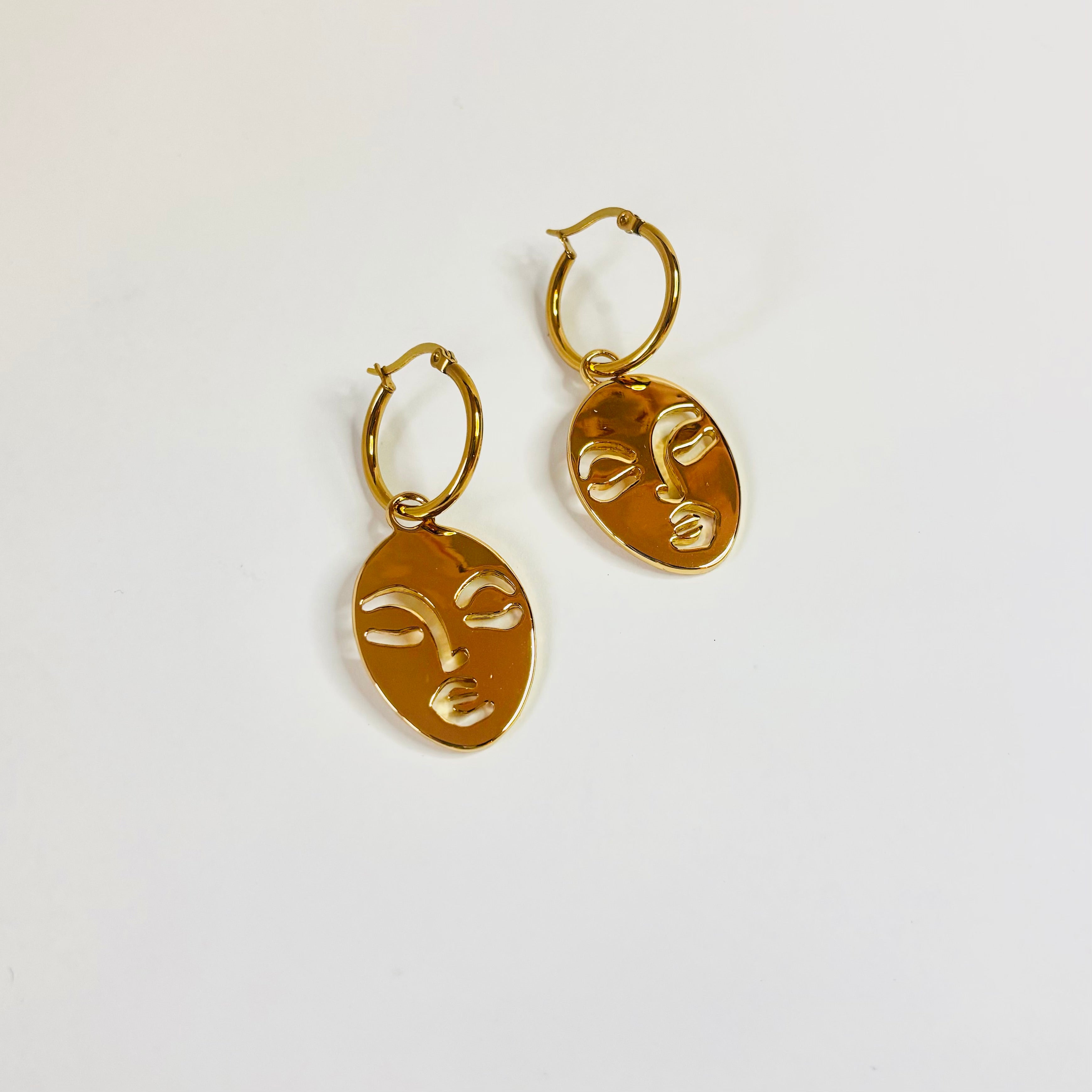 Calm and Sallow face hoop earrings