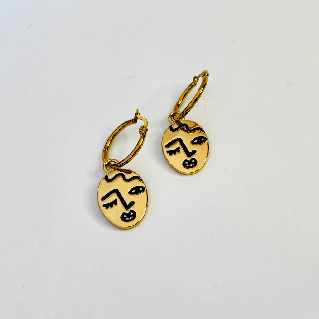 Winking lady face hoop earrings