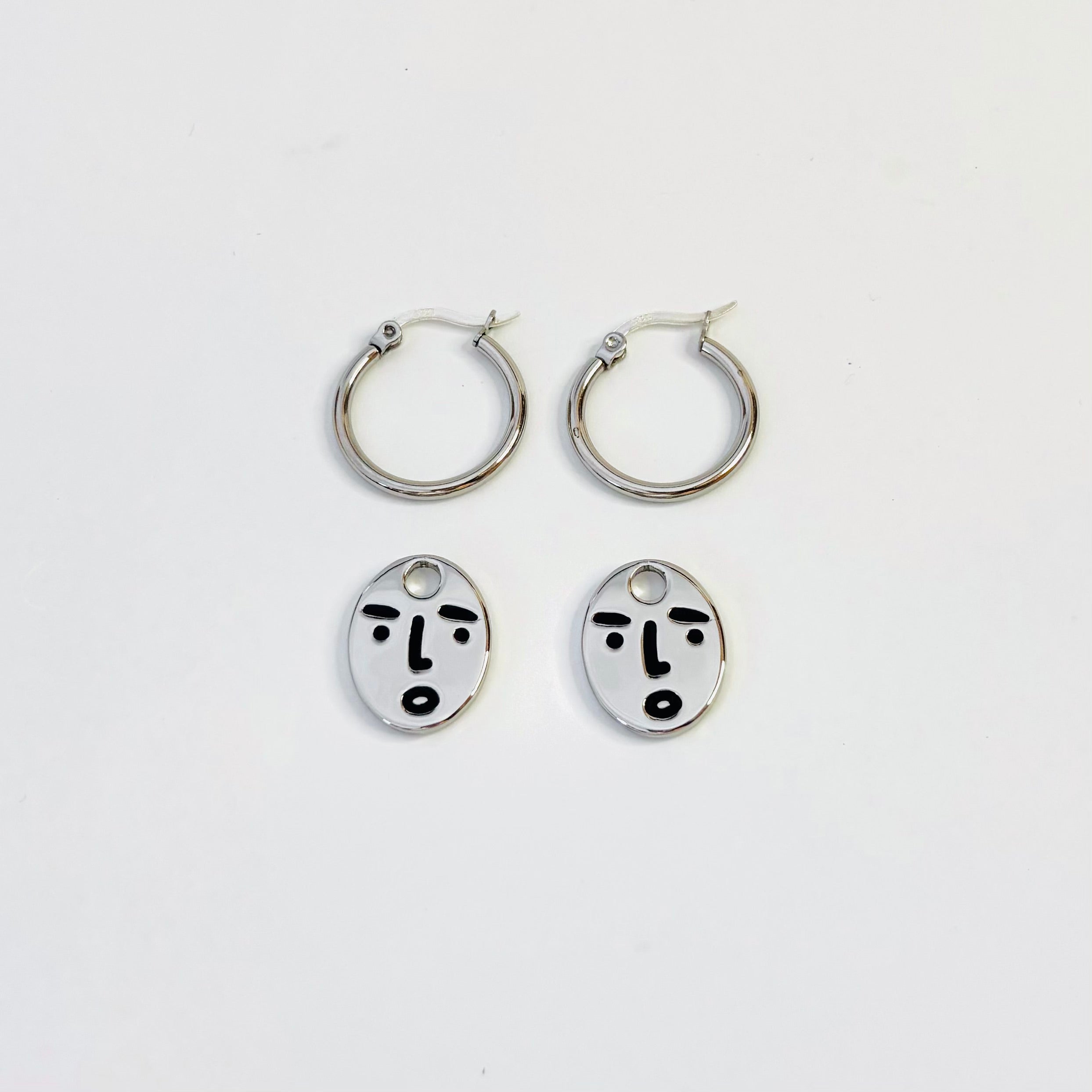 Clueless face hoop earrings