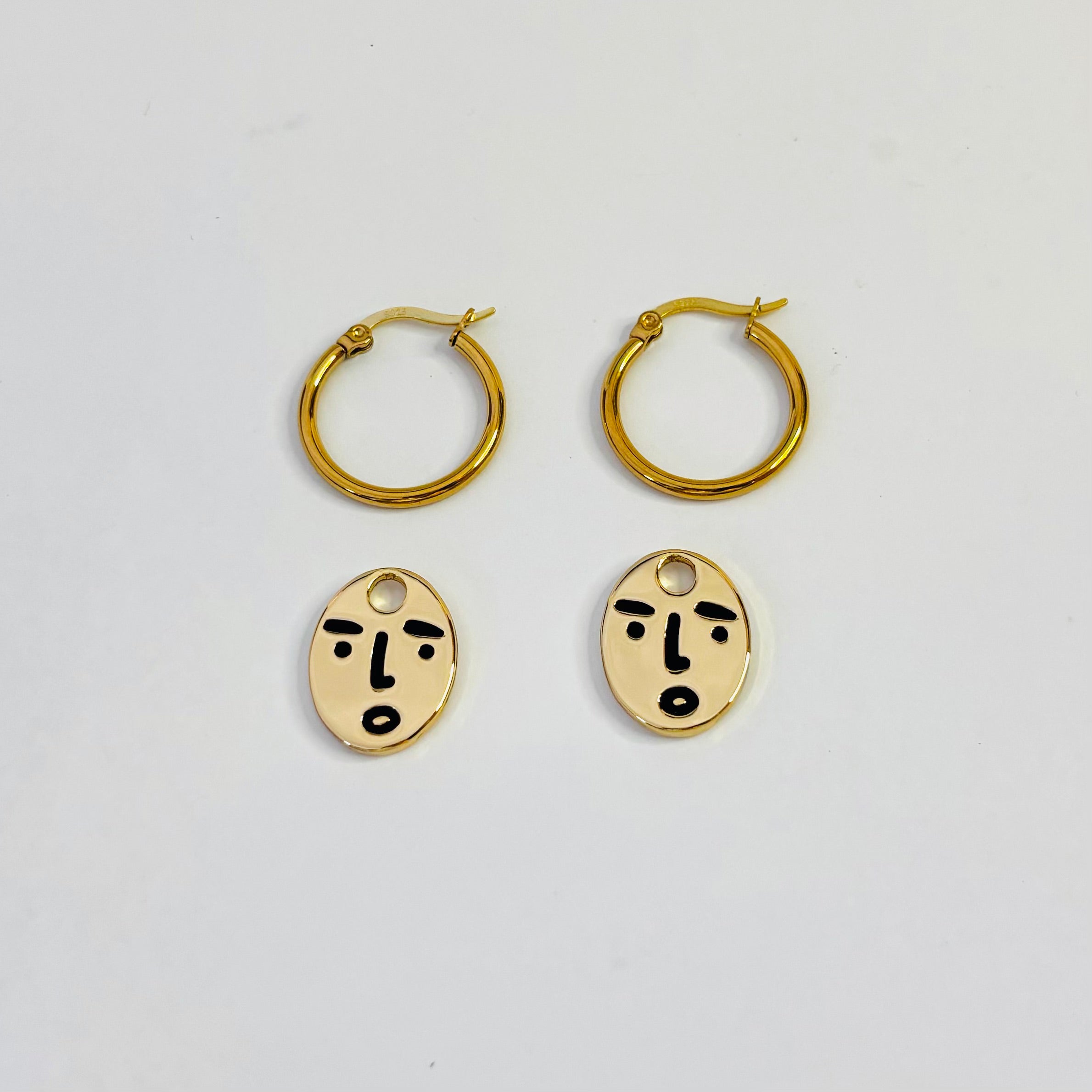 Clueless face hoop earrings