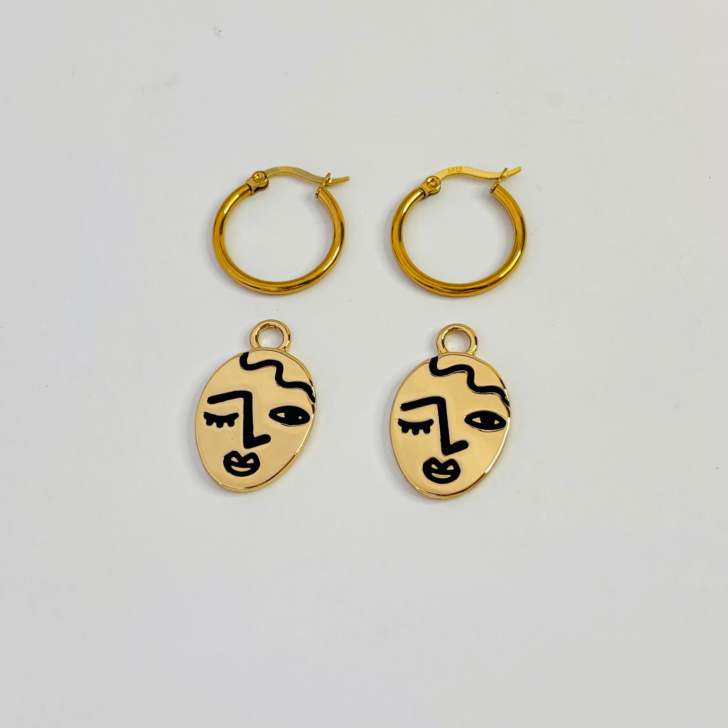 Winking lady face hoop earrings