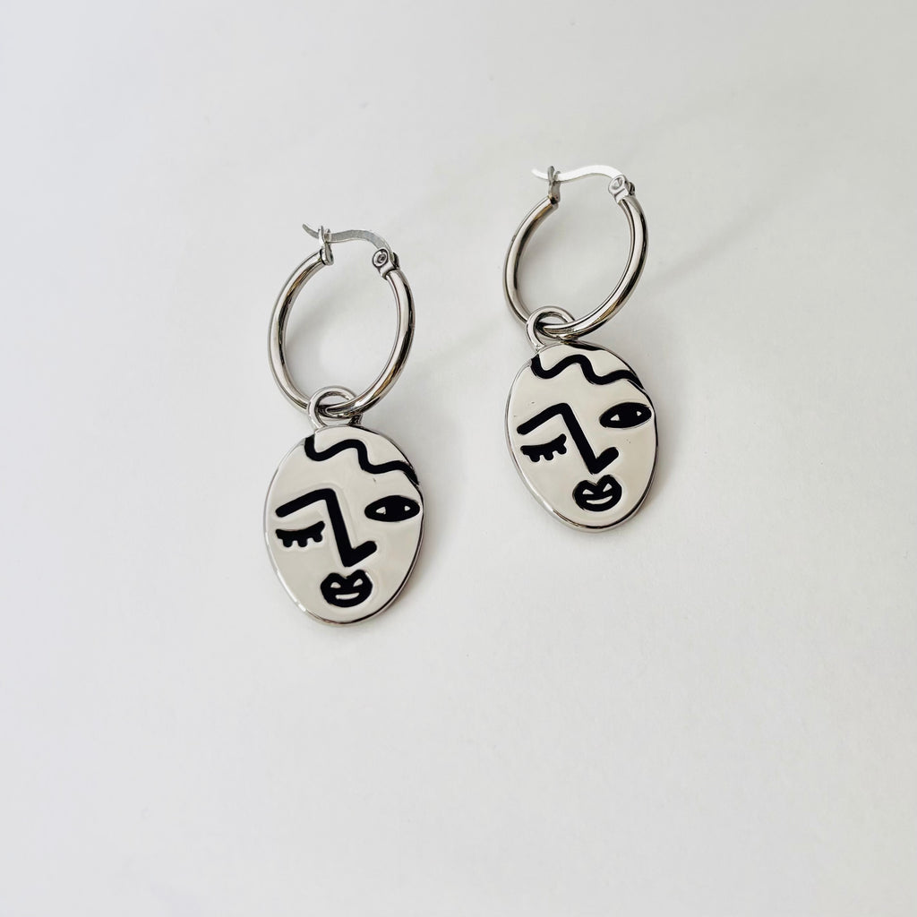 Winking lady face hoop earrings