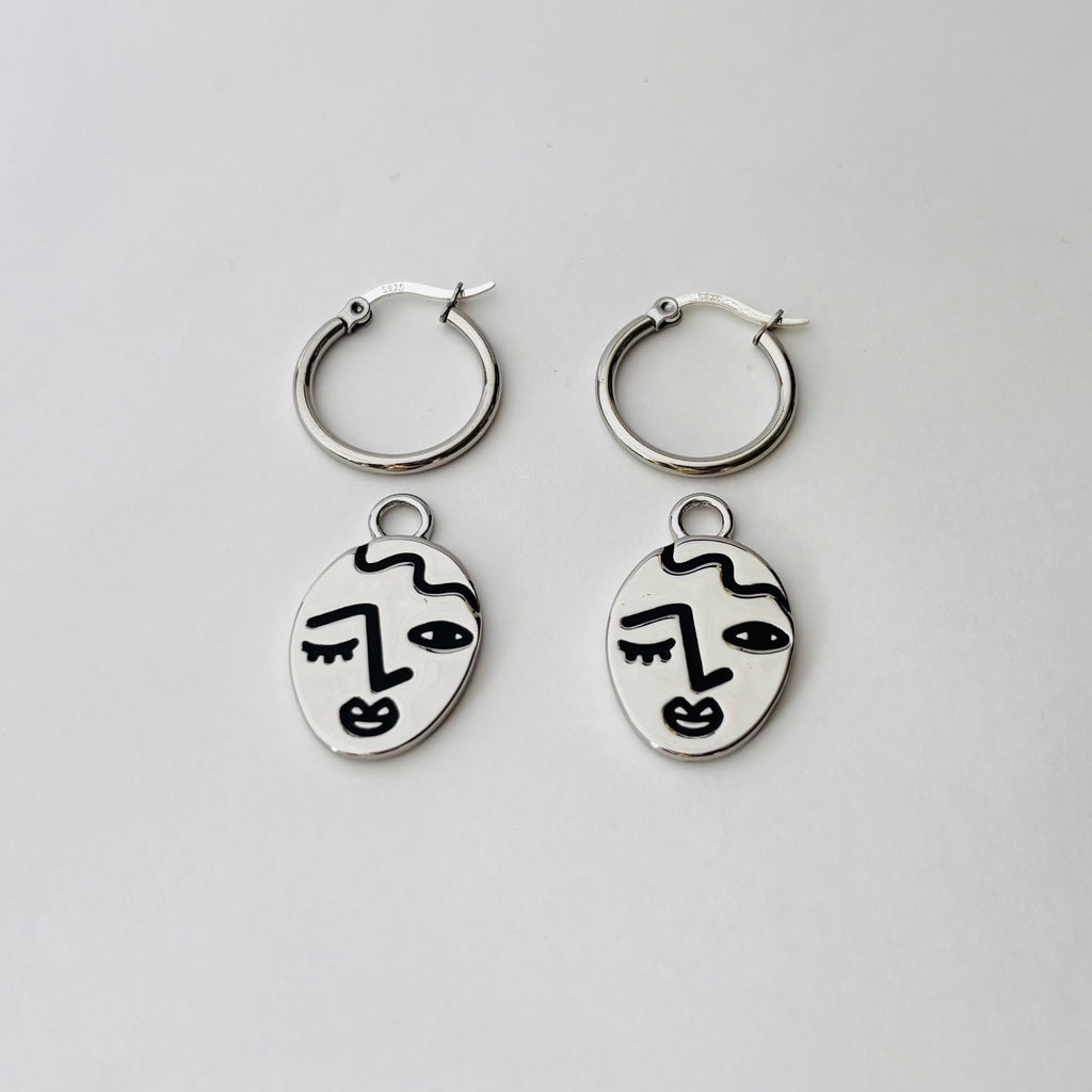 Winking lady face hoop earrings