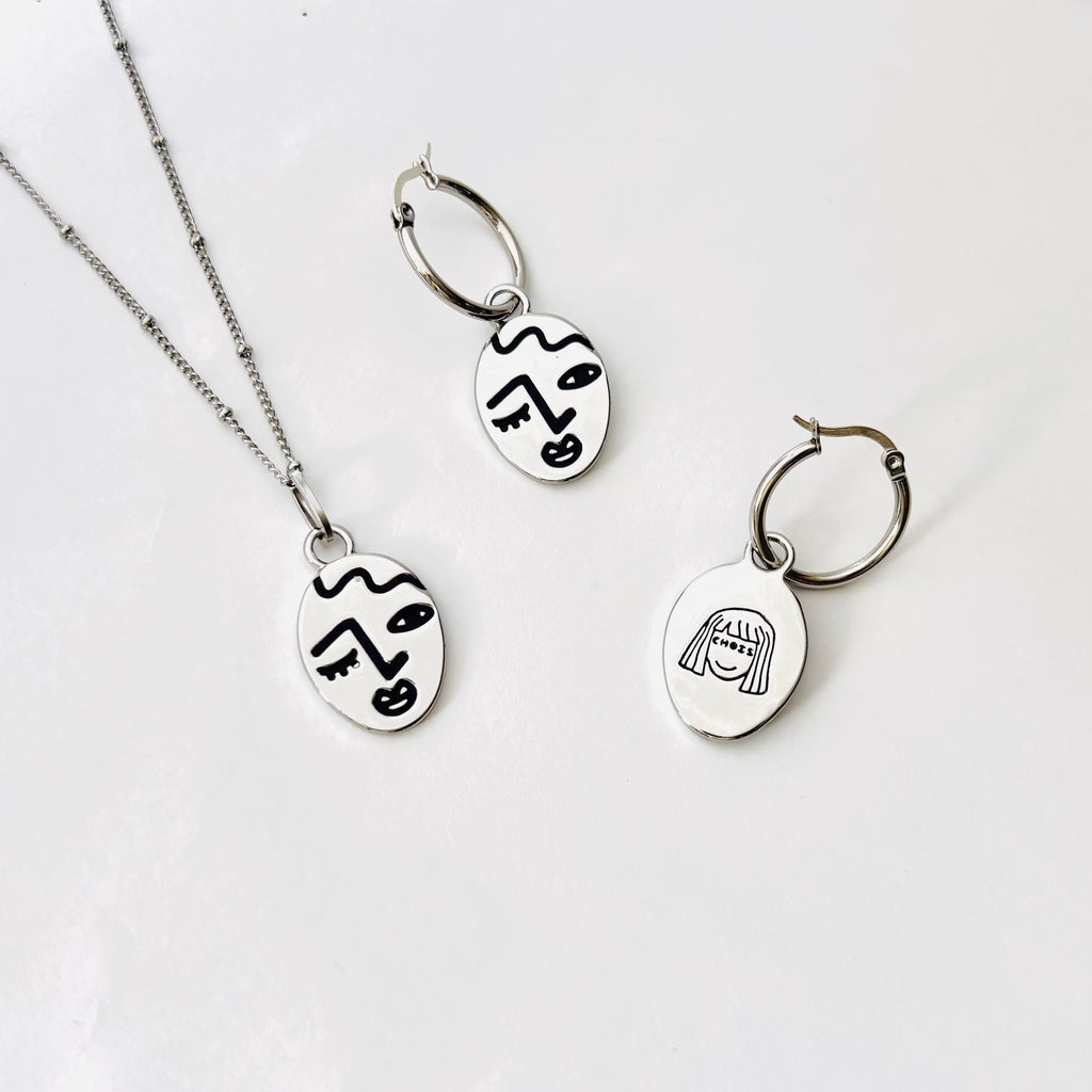 Winking lady face hoop earrings